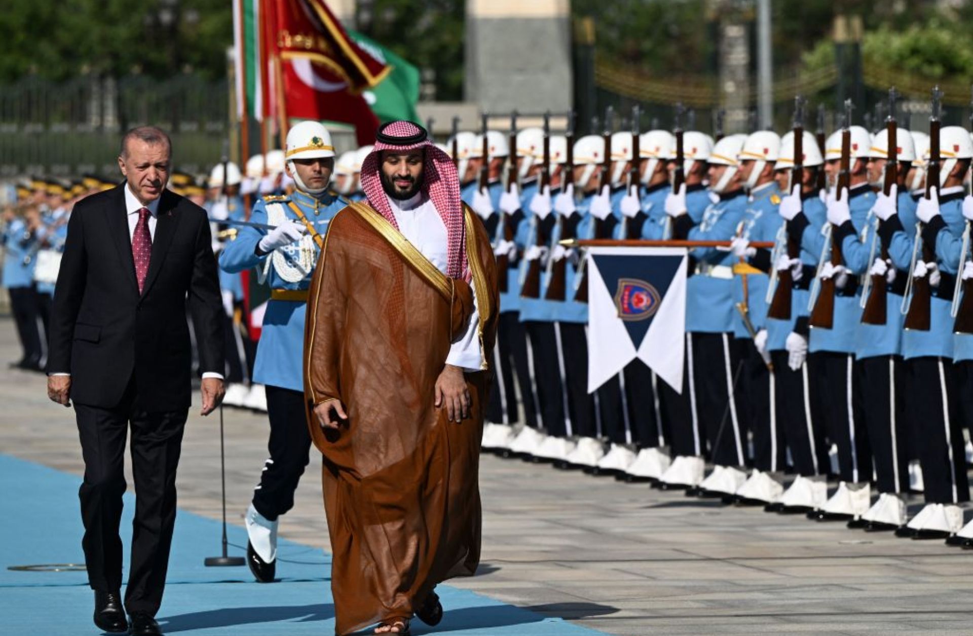 Turkish President Recep Tayyip Erdogan (L) and Saudi Crown Prince Mohammed bin Salman (R) inspect the honor guard during an official welcoming ceremony at the presidential complex in Ankara, Turkey, on June 22, 2022.