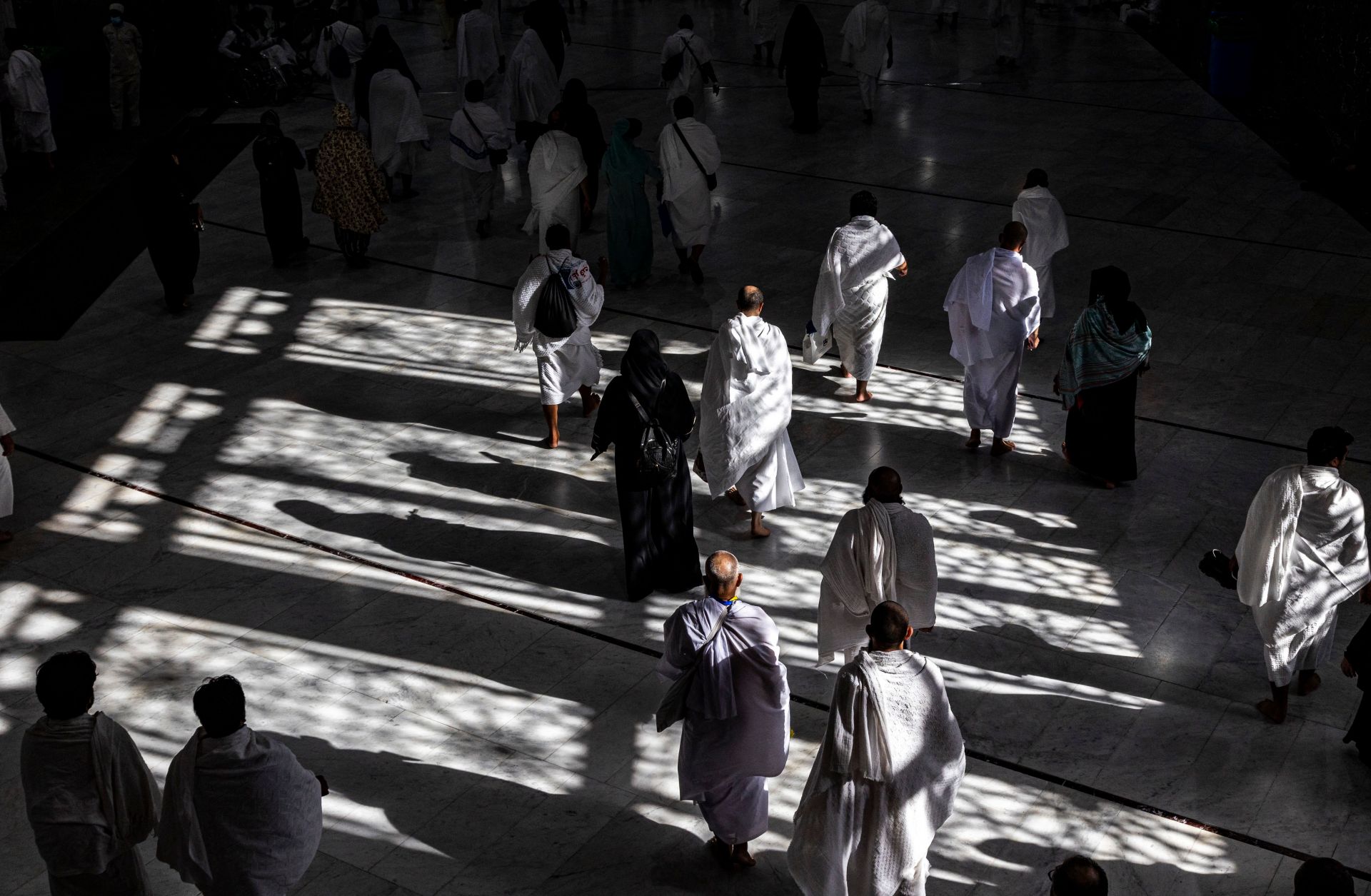 Muslim pilgrims walk at the Grand Mosque in Saudi Arabia's holy city of Mecca on July 6, 2022 during the annual hajj pilgrimage. 