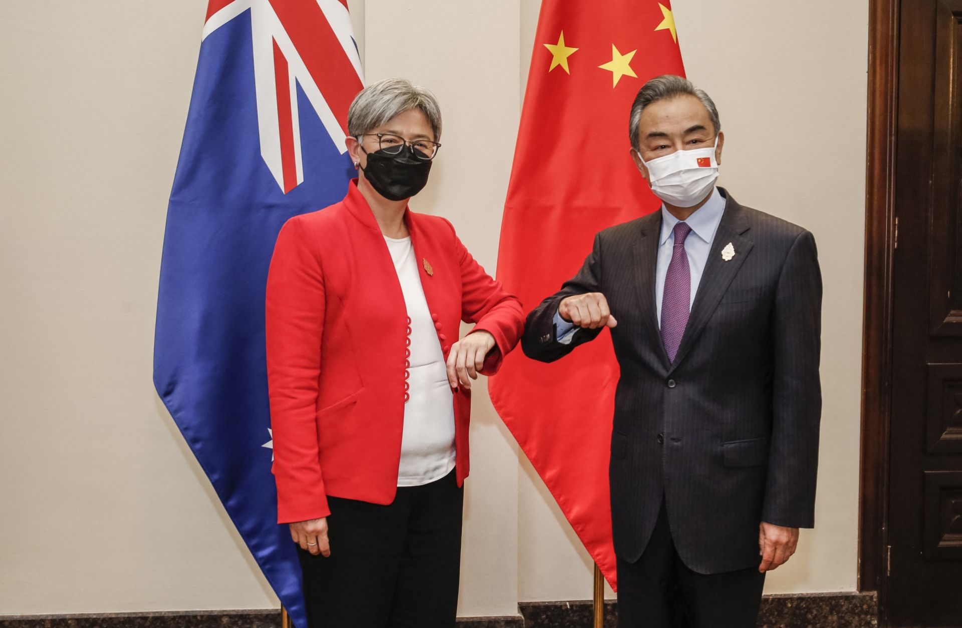 Australian Foreign Minister Penny Wong (left) bumps elbows with her Chinese counterpart Wang Yi on the sidelines of the G-20 Foreign Ministers Meeting in Bali, Indonesia, on July 8, 2022.