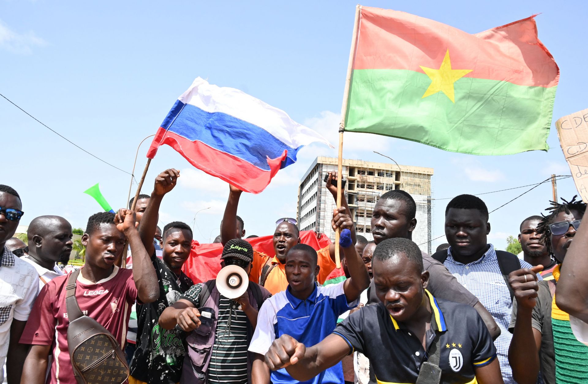 Protesters in Ouagadougou, Burkina Faso, wave Russian and Burkinabe flags on Oct. 4, 2022. 