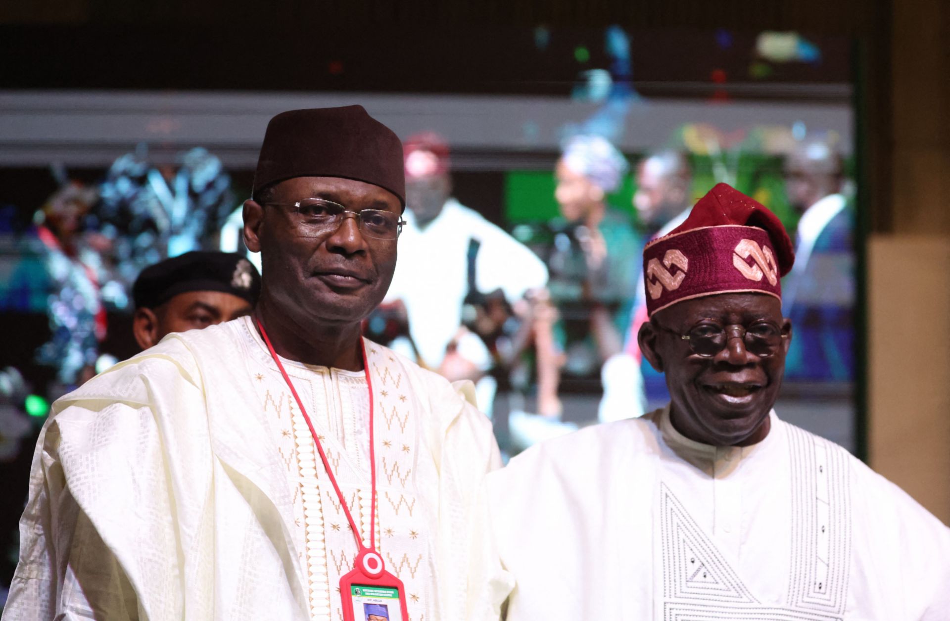 Nigerian President-elect Bola Tinubu (right) and the chairman of the country's Independent National Election Commission (INEC), Yakubu Mahmood, look on during a ceremony in Abuja on March 1, 2023. 