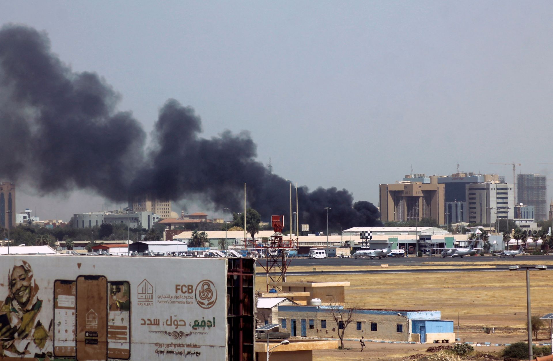 Heavy smoke billows above buildings near the Khartoum airport on April 15, 2023, amid clashes between the army and paramilitary troops. 