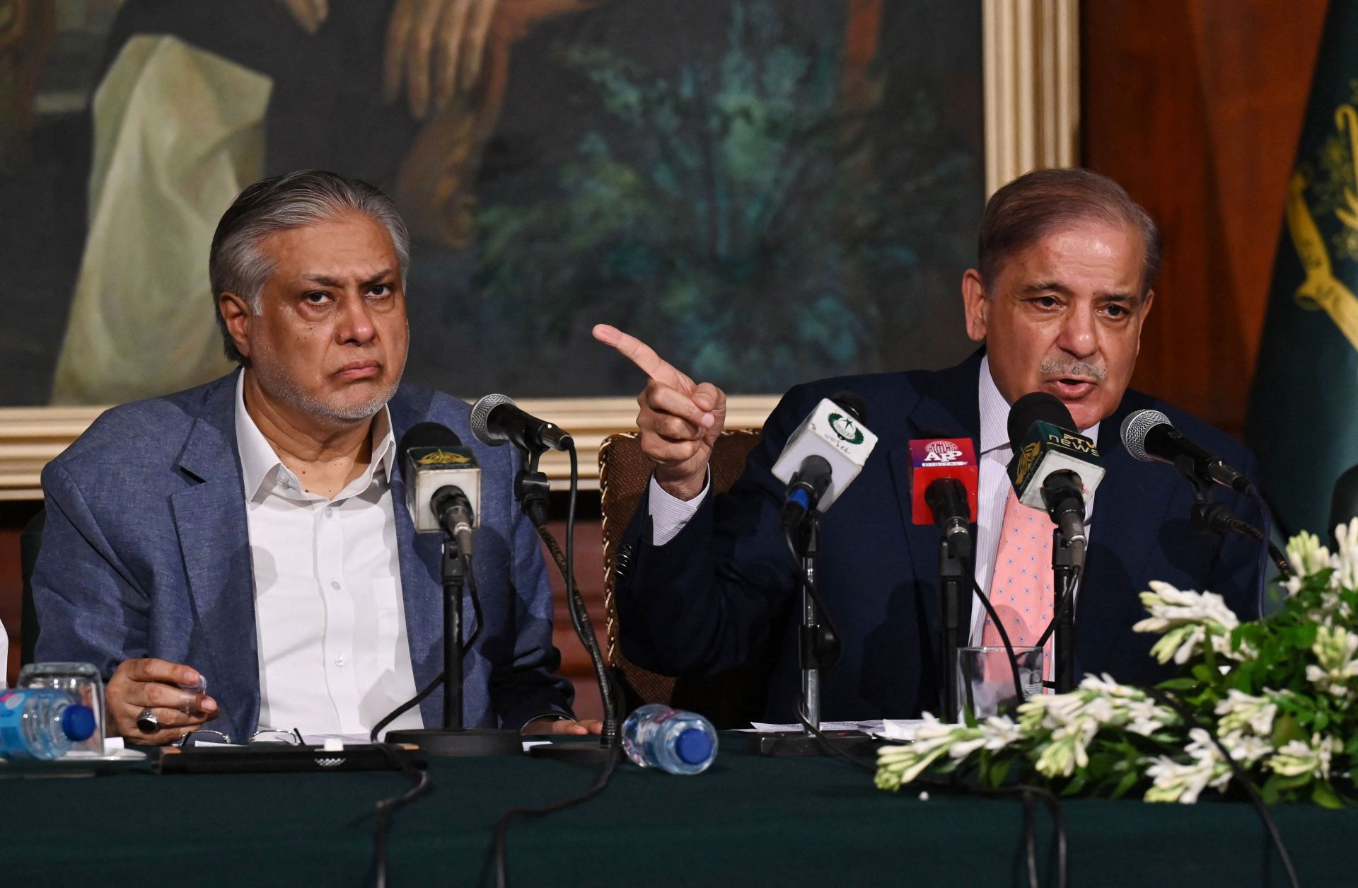 Then-Pakistani Prime Minister Shehbaz Sharif (right) and then-Pakistani Finance Minister Ishaq Dar (left) address a press conference in Lahore on June 30, 2023, after the signing of a staff-level agreement with the IMF.
