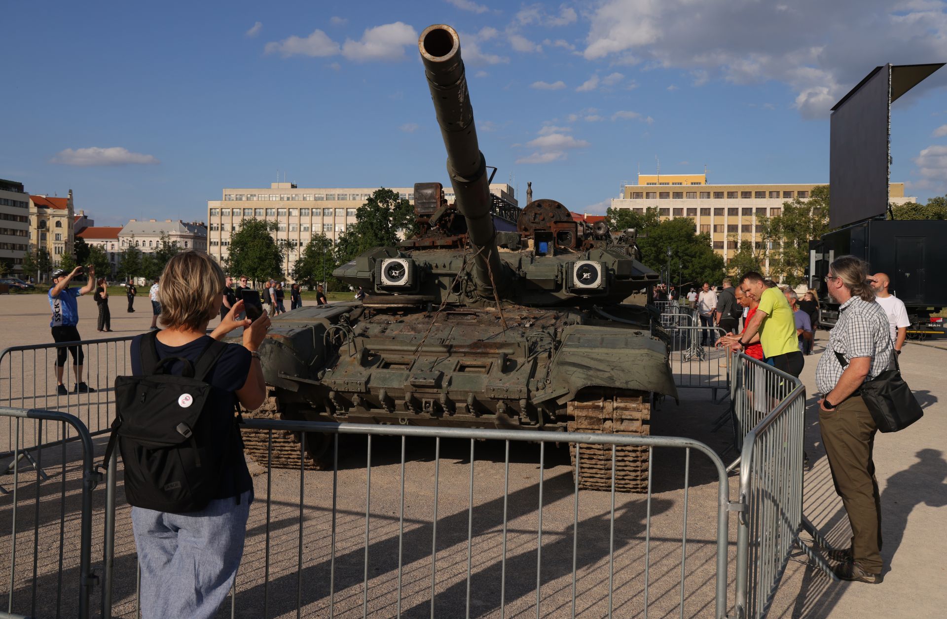 People look at a Russian T-90 tank in Prague, Czech Republic, on July 15, 2022, as part of a display of military equipment destroyed in the war in Ukraine. 