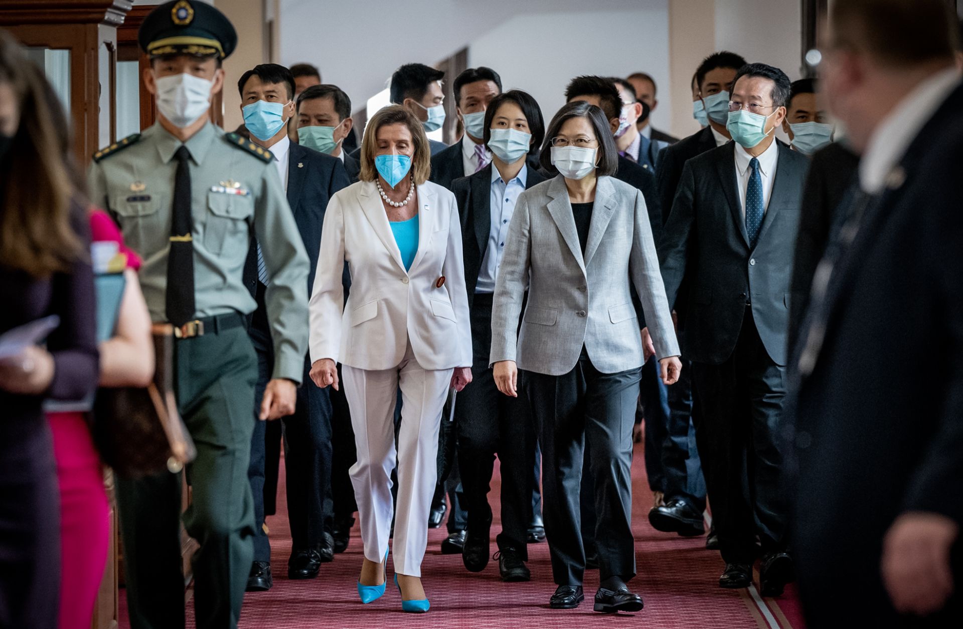 Then-U.S. House Speaker Nancy Pelosi (center left) walks alongside Taiwanese President Tsai Ing-wen after arriving at the president's office in Taipei on Aug. 3, 2022. 