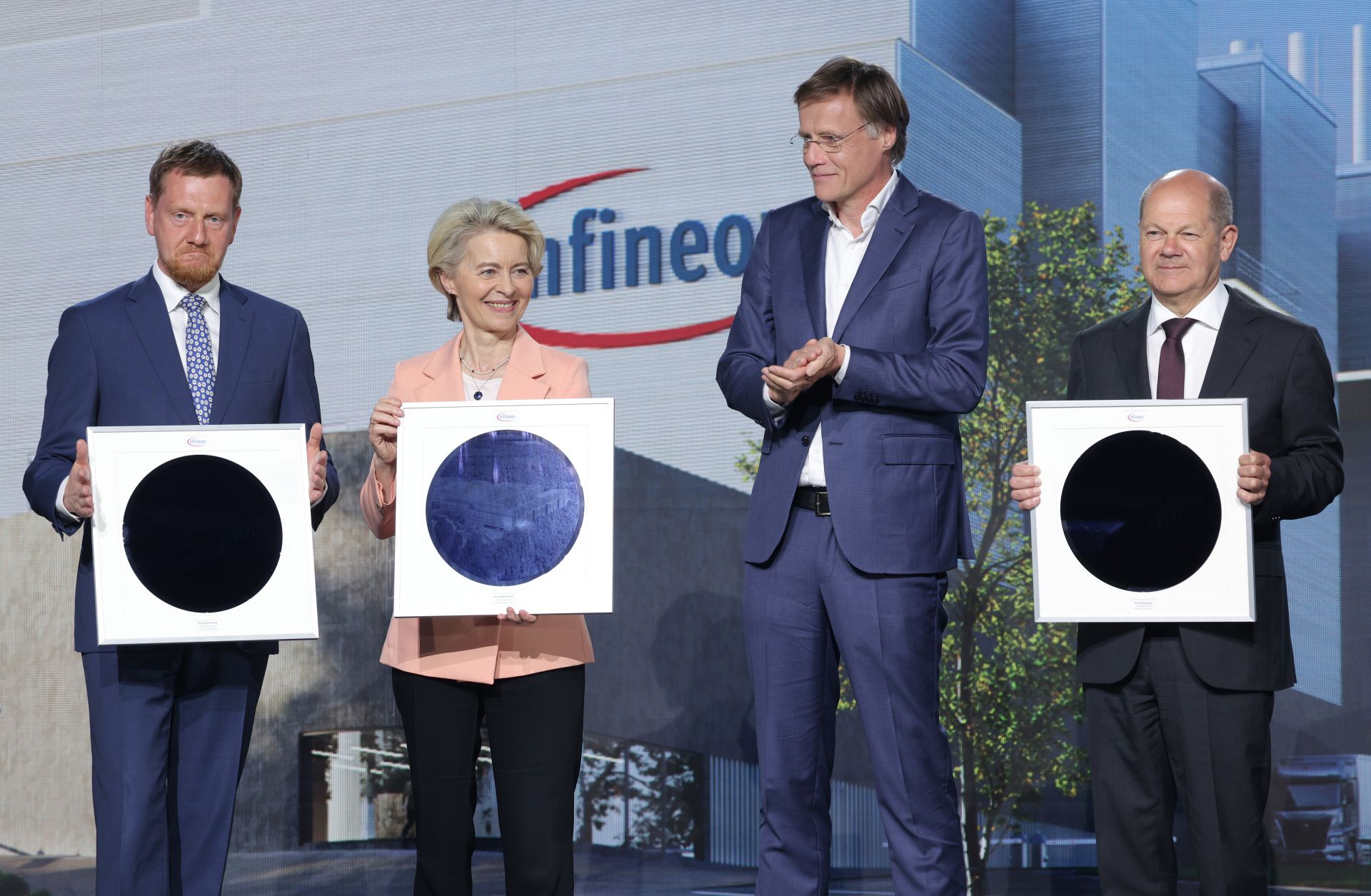 (L-R) Saxony Premier Michael Kretschmer, European Commission President Ursula von der Leyen and German Chancellor Olaf Scholz hold semiconductor wafers as Infineon CEO Jochen Hanebeck (second from right) looks on during a ground-breaking ceremony for a new semiconductor factory in Dresden, Germany, on May 2, 2023. 