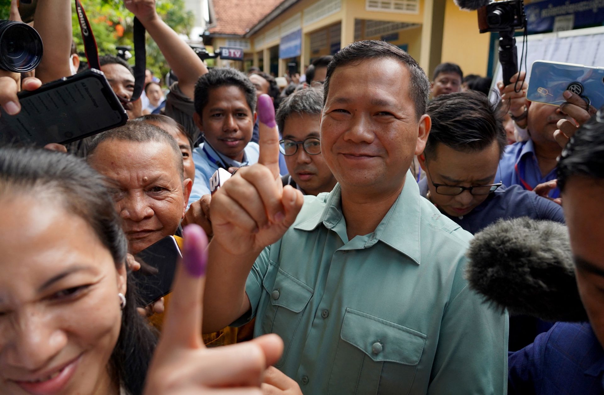 Hun Manet, the eldest son of Cambodia's long-ruling prime minister Hun Sen, shows his finger after voting in the country's general election in Phnom Penh on July 23, 2023. 