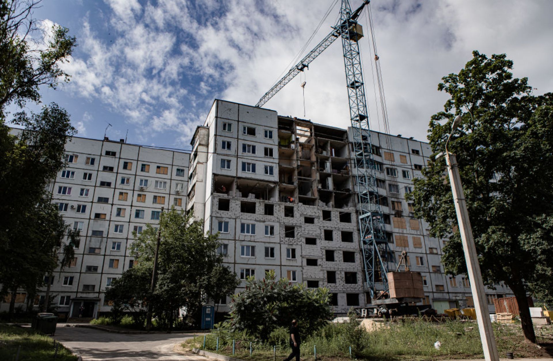 City authorities and businesses rebuild residential buildings damaged by Russian shelling in Kharkiv, Ukraine, on July 12, 2023.