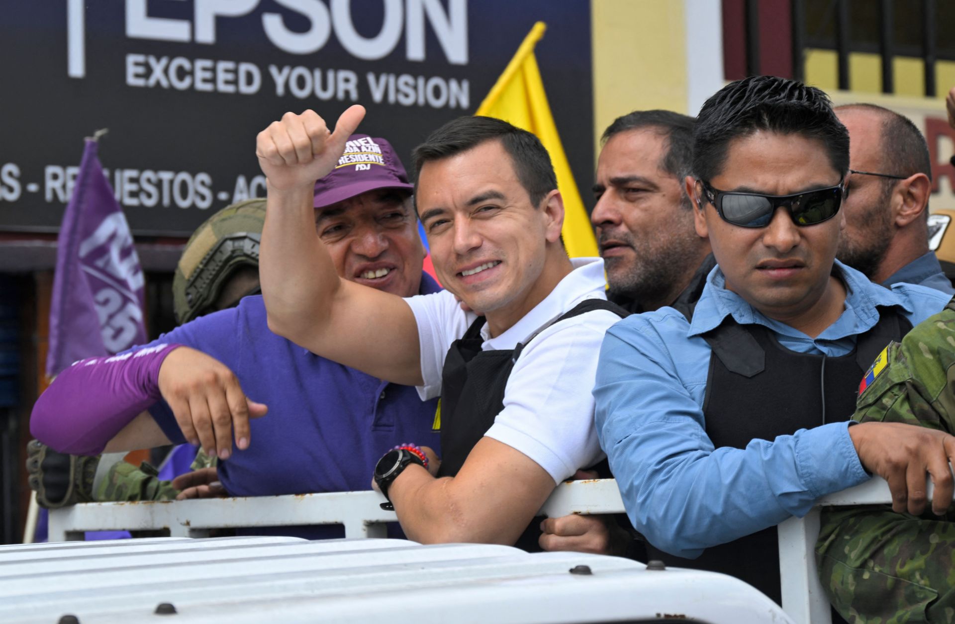 Ecuadorean presidential candidate Daniel Noboa (center) gives a thumbs up as he rides on top of a truck during a campaign caravan in Quito, Ecuador, on Oct. 11, 2023. 