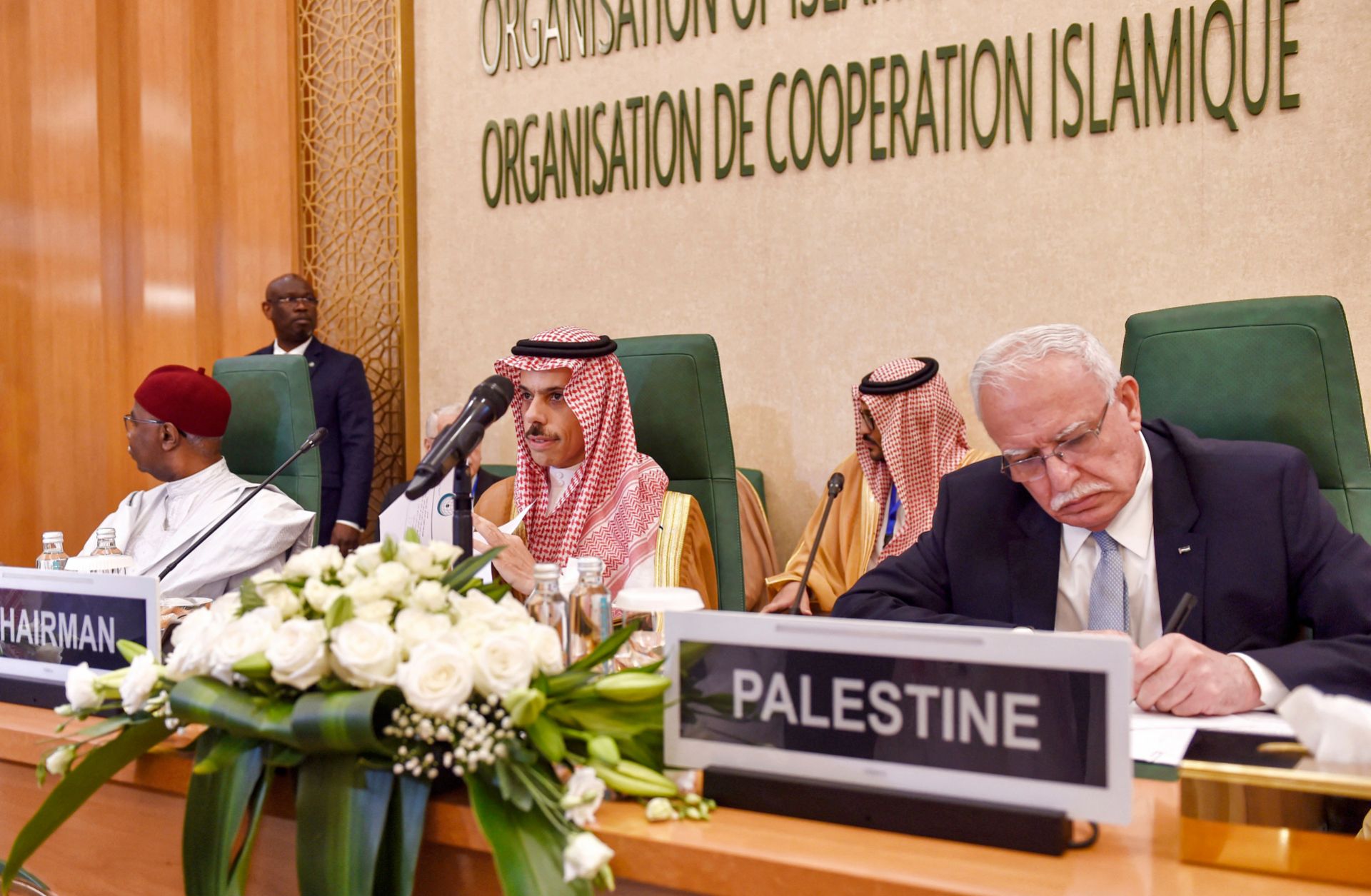 Saudi Foreign Minister Prince Faisal bin Farhan (center) sits next to his Palestinian counterpart during an extraordinary meeting of the Organization of Islamic Cooperation's executive committee regarding the situation in Gaza on Oct. 18, 2023 in Jeddah, Saudi Arabia.