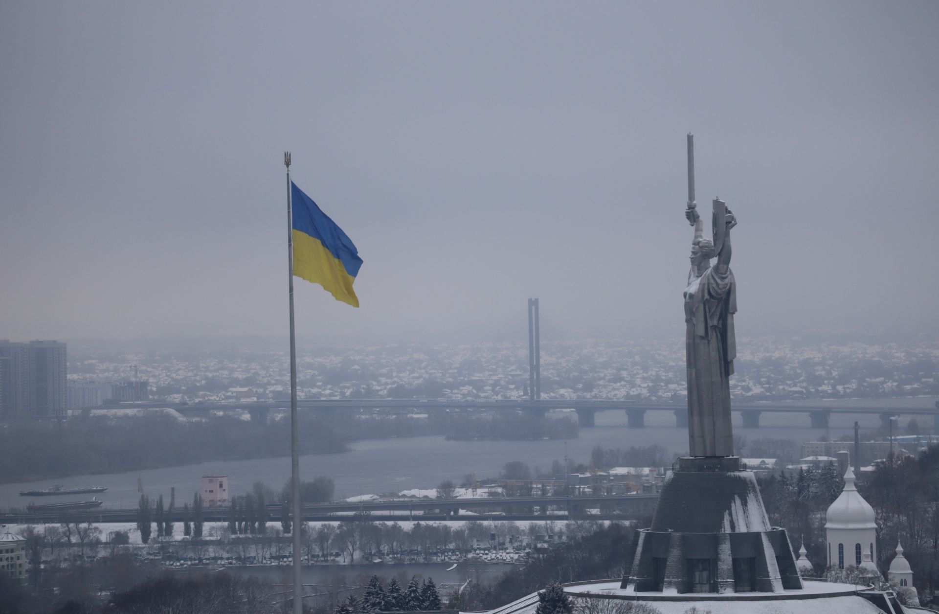 A Ukrainian flag flies near the Great Lavra Bell Tower of the Motherland Monument in Kyiv, Ukraine, on Nov. 22, 2023.