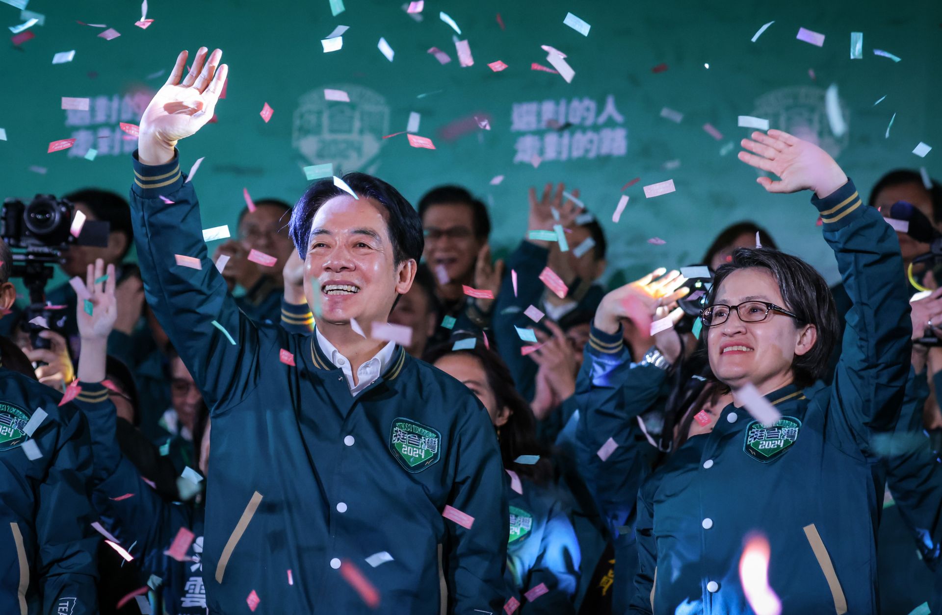 Taiwanese President-Elect, William Lai (left), celebrates alongside his running mate (right) during a rally at the headquarters of the Democratic Progressive Party (DPP) in Taipei, Taiwan, on Jan. 13, 2024, after winning the presidential election.