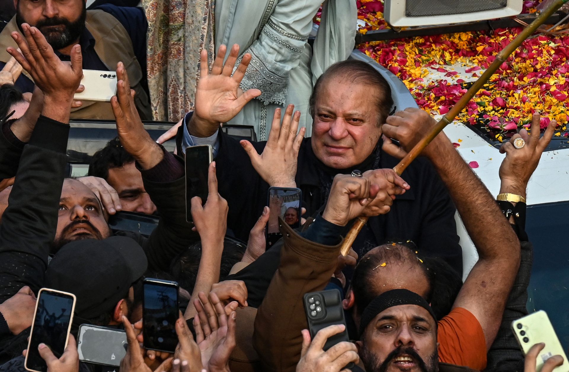 Pakistan's former prime minister and the leader of the Pakistan Muslim League-Nawaz party, Nawaz Sharif (center), waves to supporters during a campaign rally in Lahore, Pakistan, on Jan. 23, 2024. 