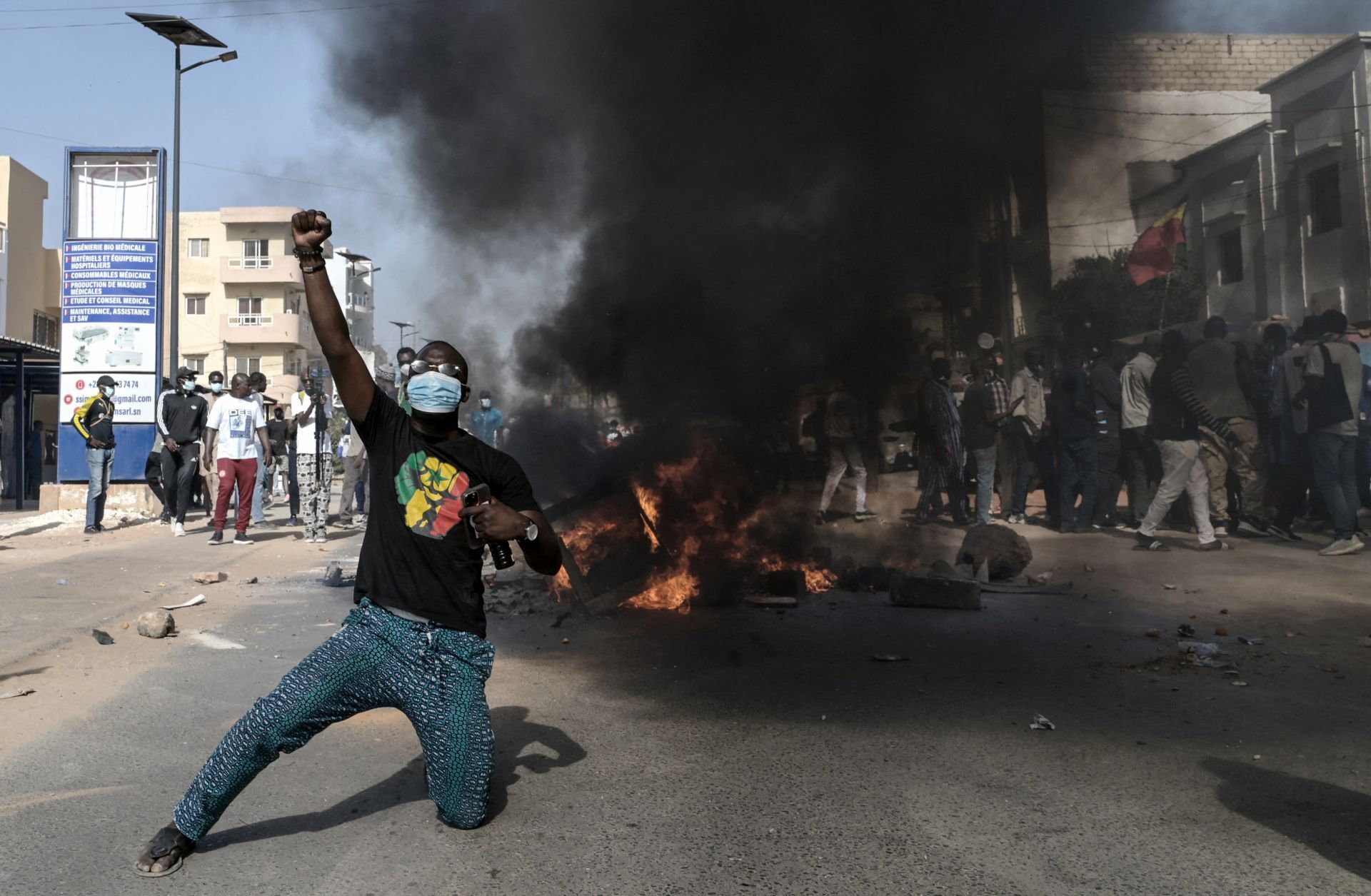 An opposition supporter reacts in front of a burning barricade during demonstrations in Dakar, Senegal, on Feb. 4, 2024, after President Macky Sall announced the postponement of the presidential election. 