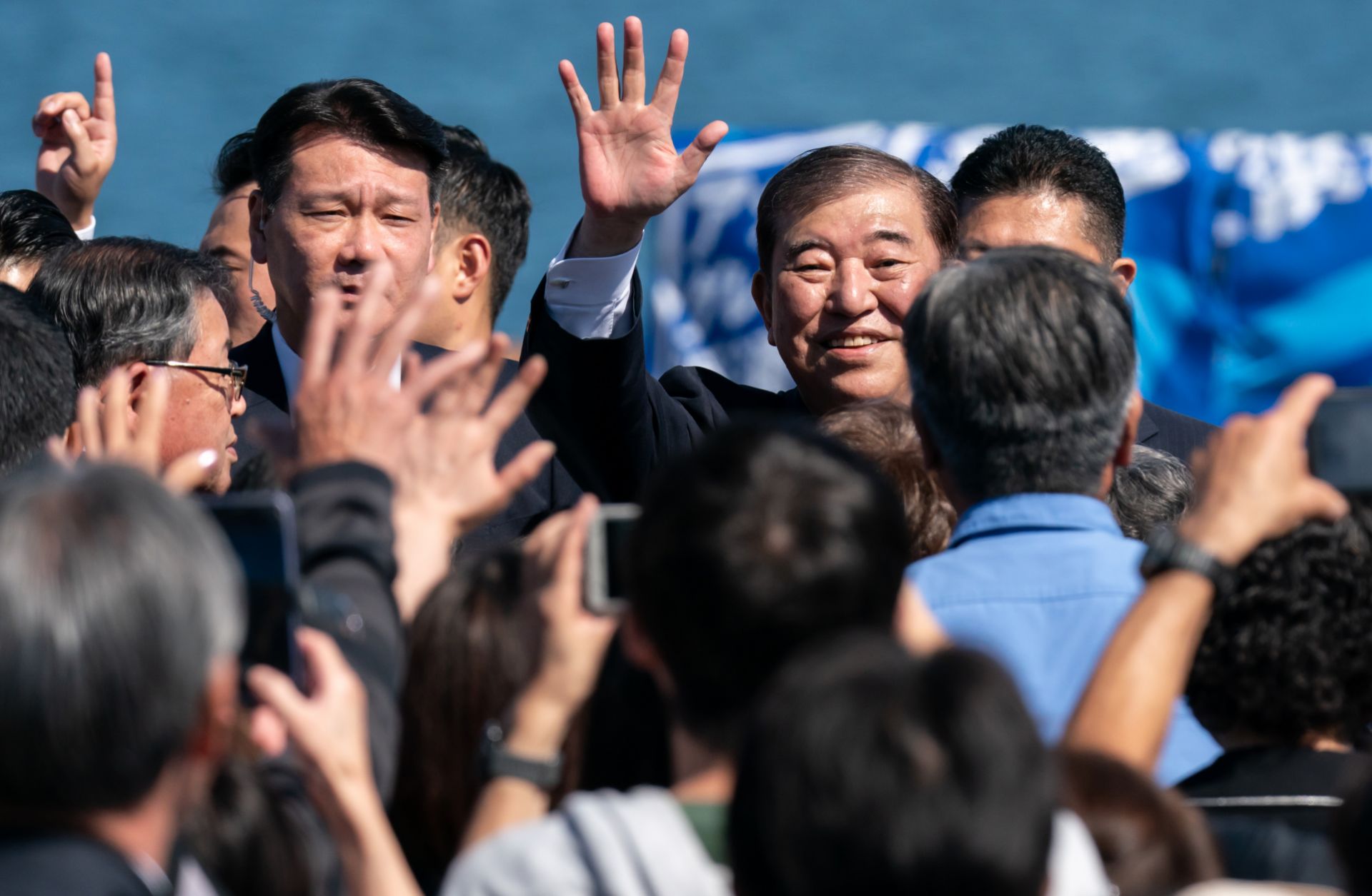 Japanese Prime Minister Shigeru Ishiba (center) waves as he arrives for a campaign rally at Onahama Port in Iwaki, Japan, on Oct. 15, 2024. 