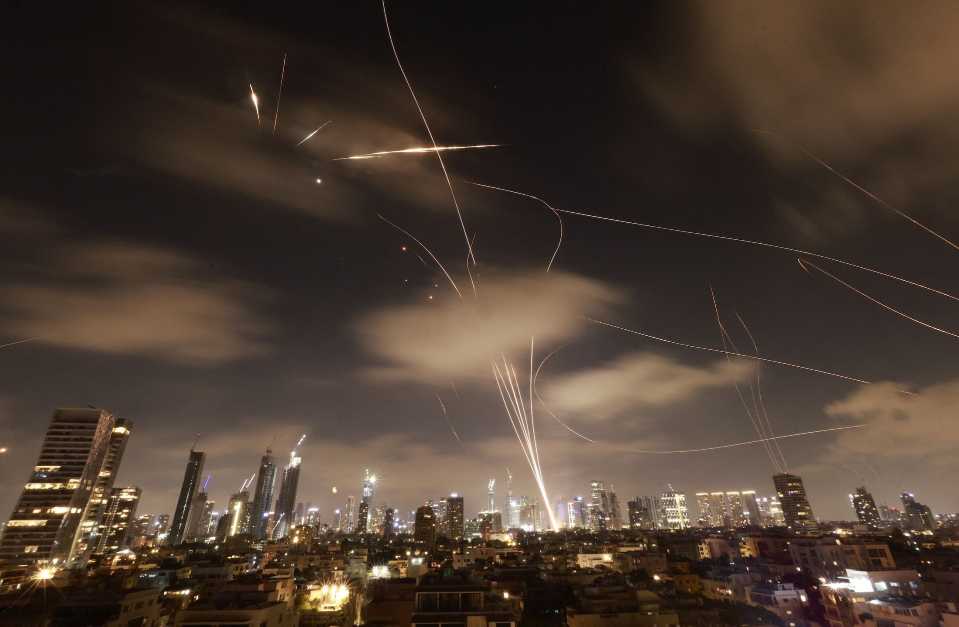 Israeli air defense systems are activated to intercept Iranian missiles over the Israeli city of Tel Aviv early on June 18, 2025. 
