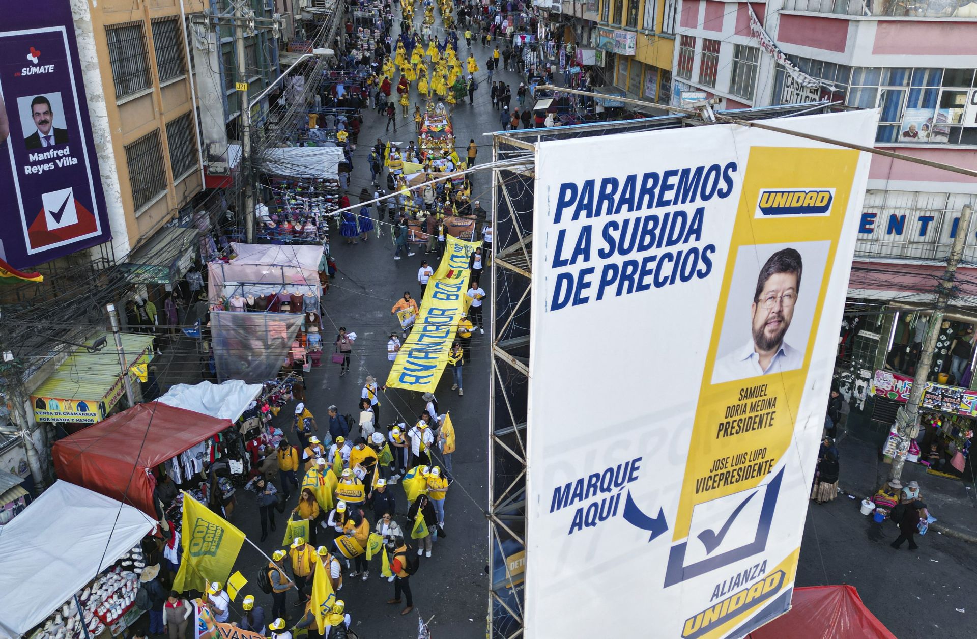 An aerial view shows a campaign poster of Bolivian presidential candidate Samuel Doria Medina and his supporters marching during a rally in La Paz, Bolivia, on Aug. 12, 2025.