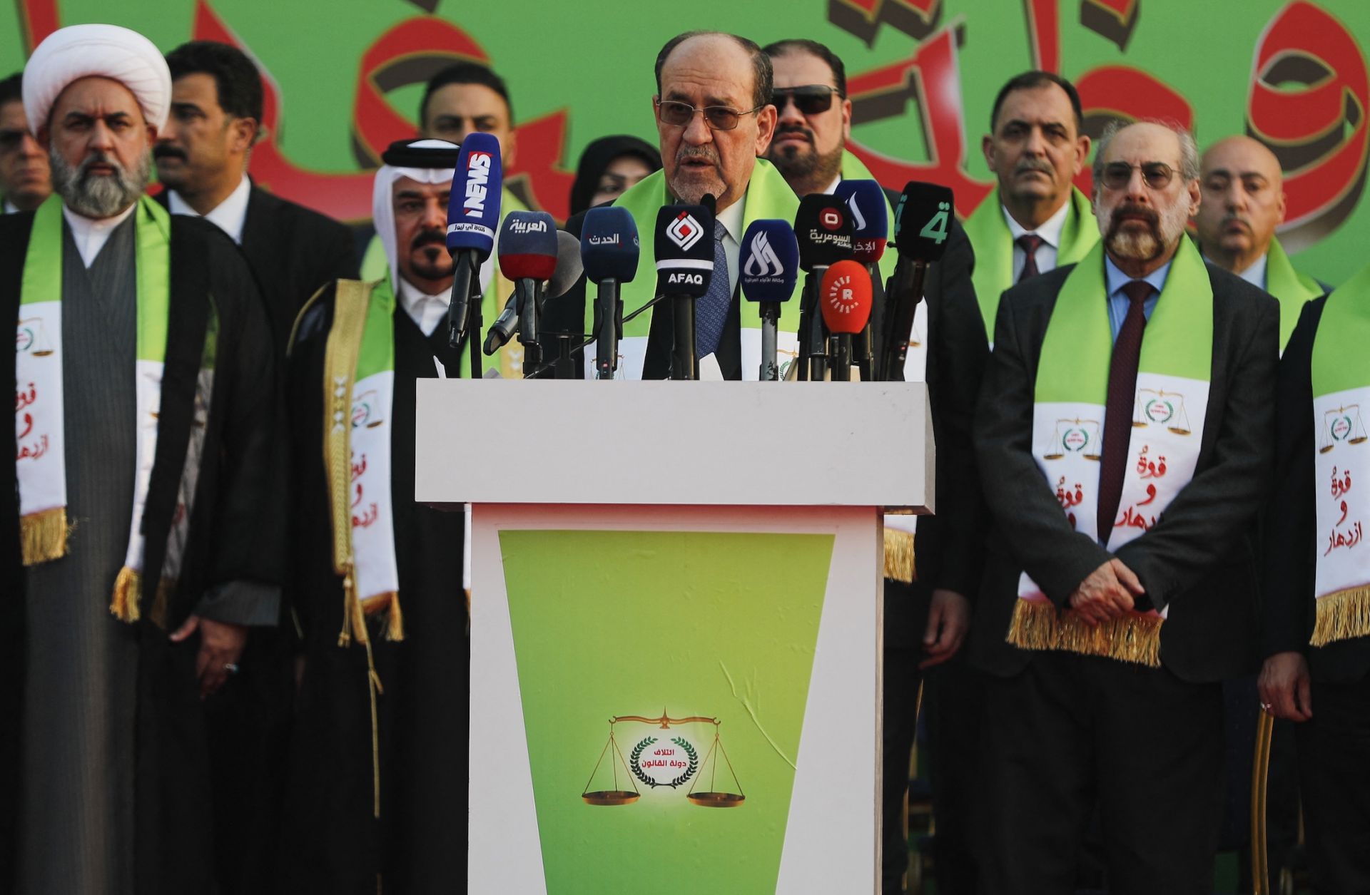 Former Iraqi Prime Minister Nouri al-Maliki (center) delivers a speech during a campaign rally in Baghdad ahead of parliamentary elections on Nov. 7, 2025. 