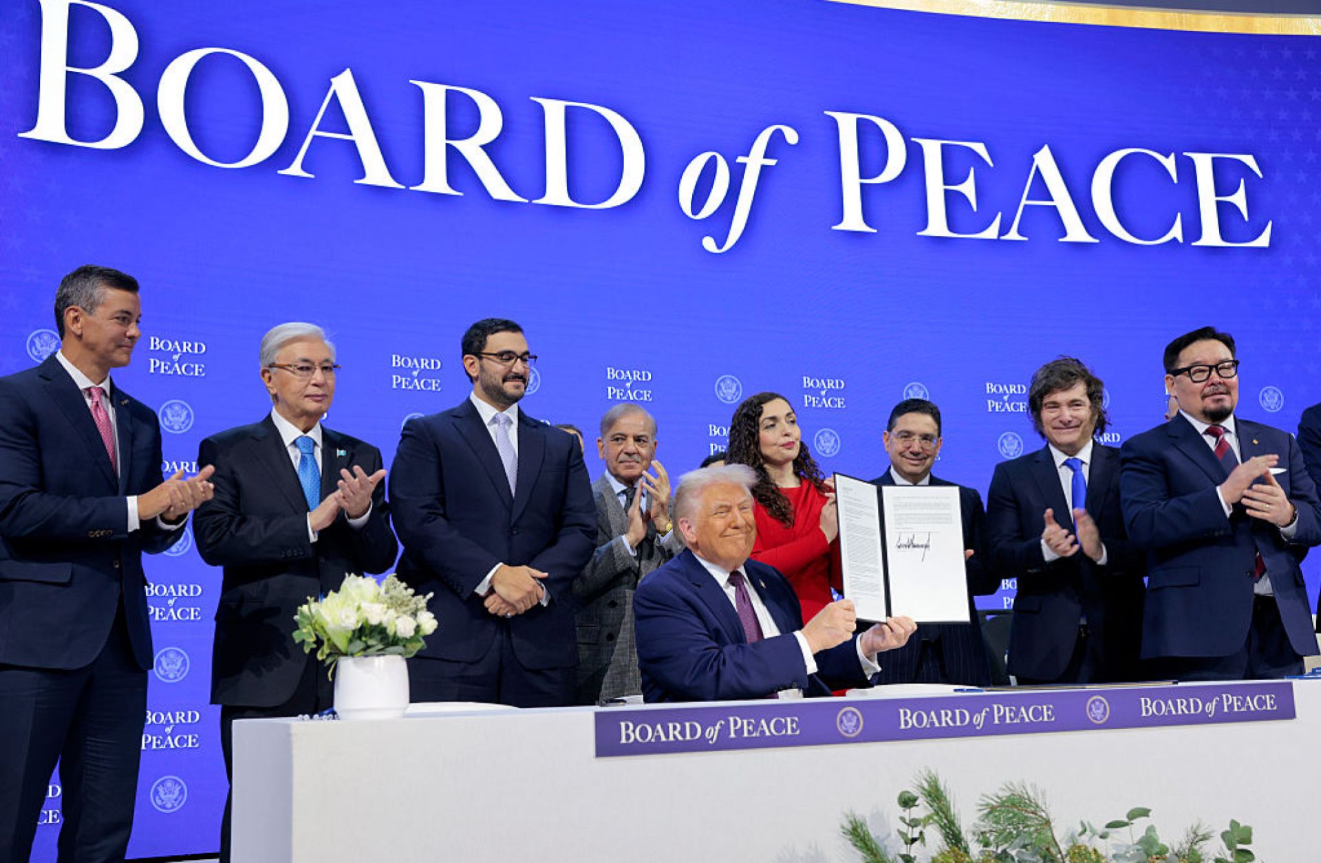U.S. President Donald Trump (C) holds up his signature on the founding charter of the Board of Peace among other world leaders at the World Economic Forum on Jan. 22 in Davos, Switzerland.
