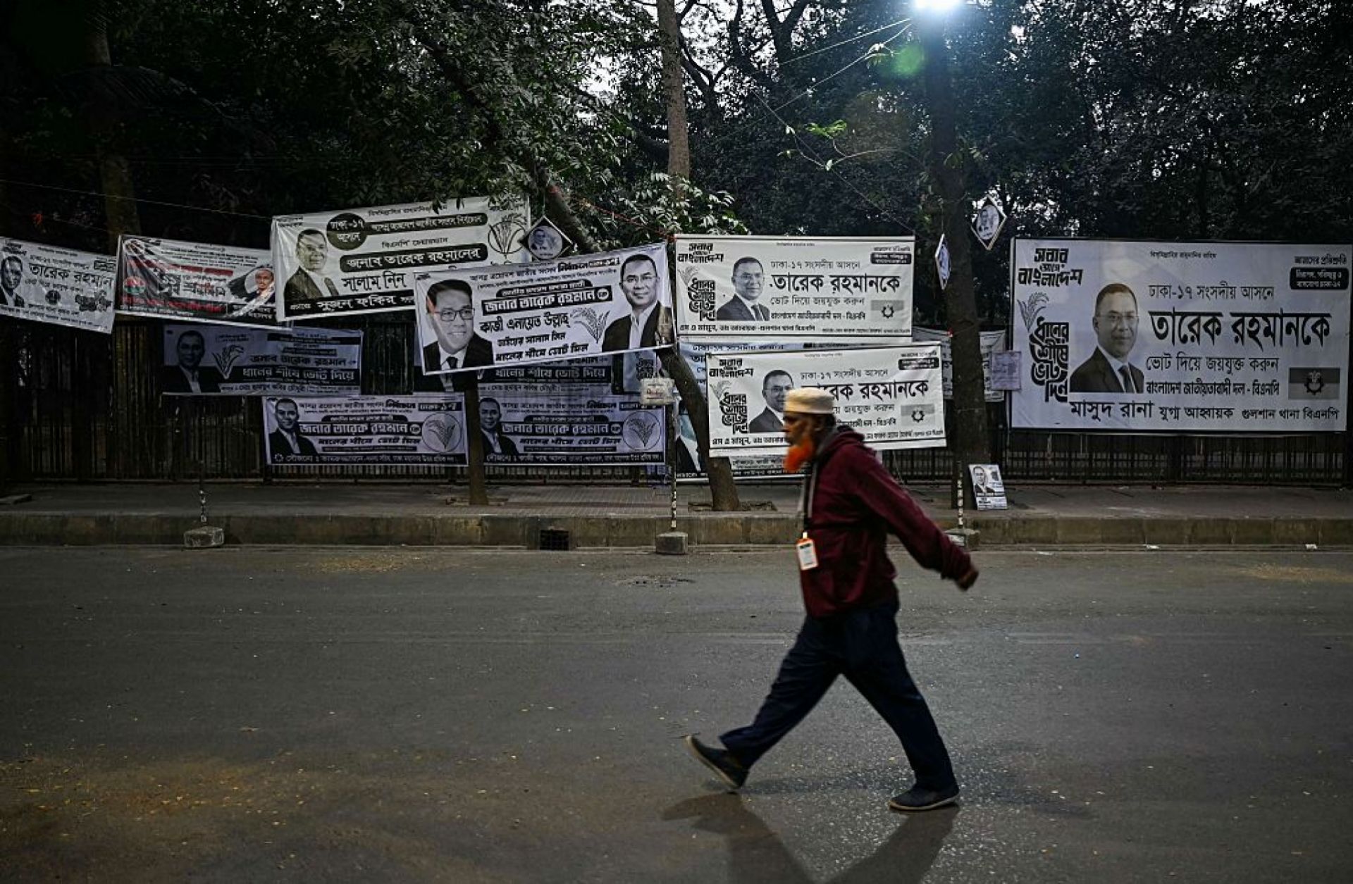 A man walks past campaign posters of Bangladesh Nationalist Party (BNP) chairman and Tarique Rahman in Dhaka on Feb. 13, 2026.