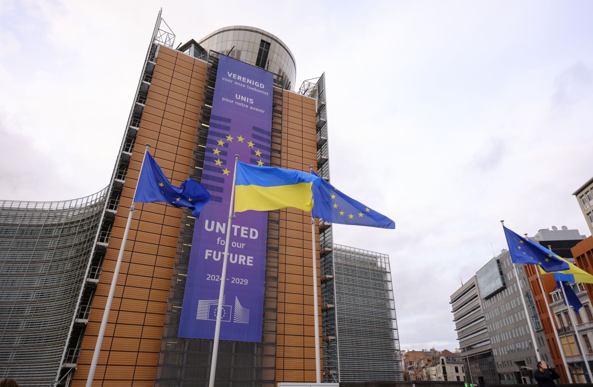 EU and Ukrainian flags fly outside the European Commission headquarters on Feb. 23, 2025, in Brussels, Belgium.
