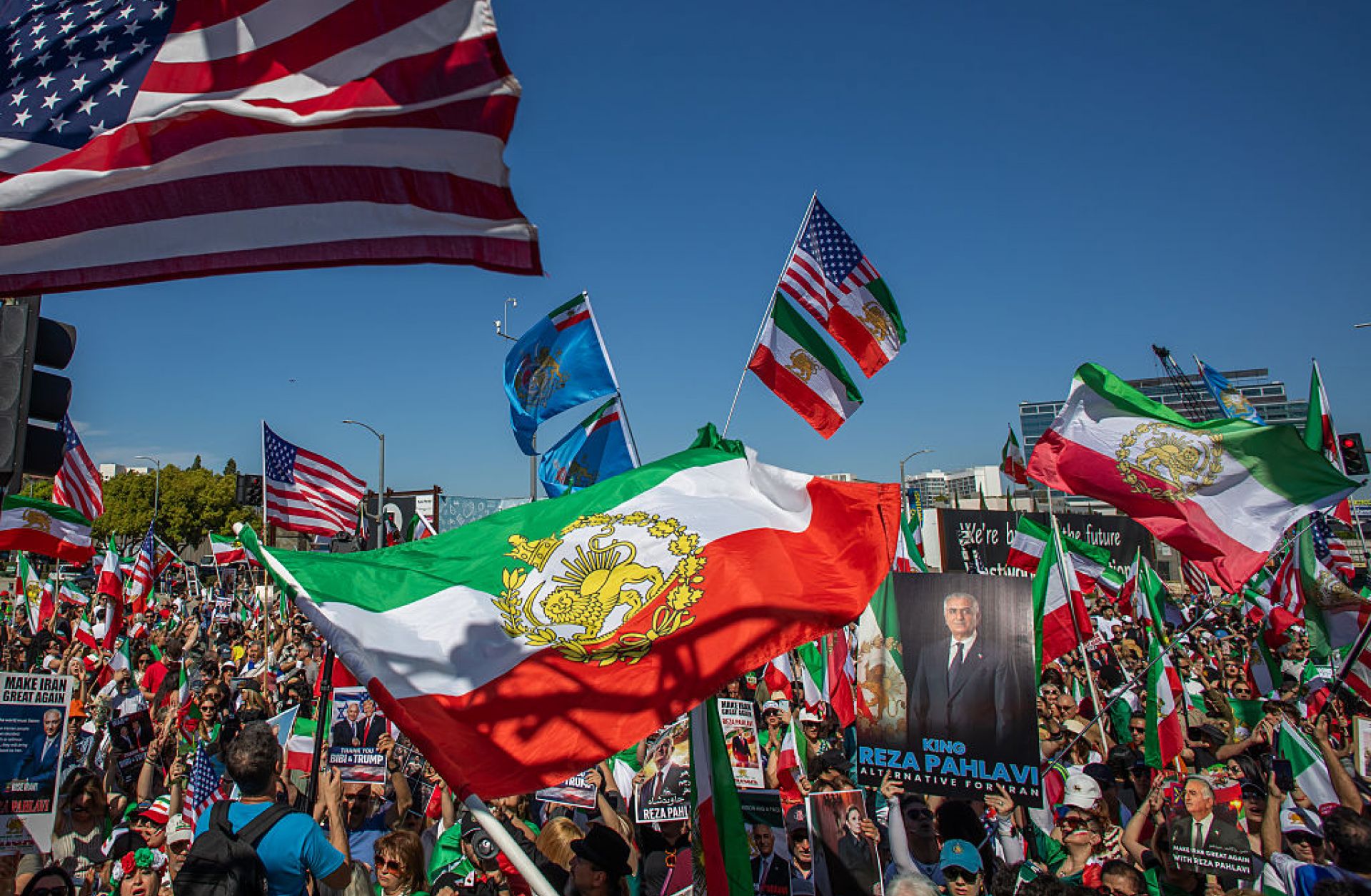 People wave Iranian pre-1979 Islamic Revolution and American flags while members of the Iranian community celebrate in front of the Federal Building on March 1, in Los Angeles. 