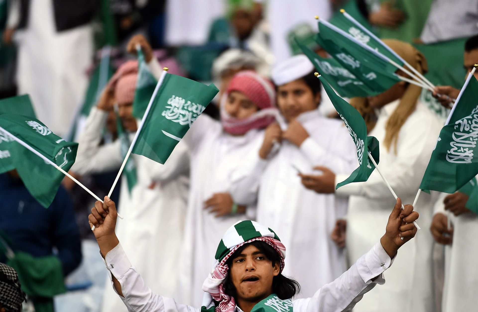 Fans of the Saudi national football team cheer during a match against Qatar at the King Fahad International Stadium in Riyadh, Saudi Arabia, on Nov. 26, 2014.