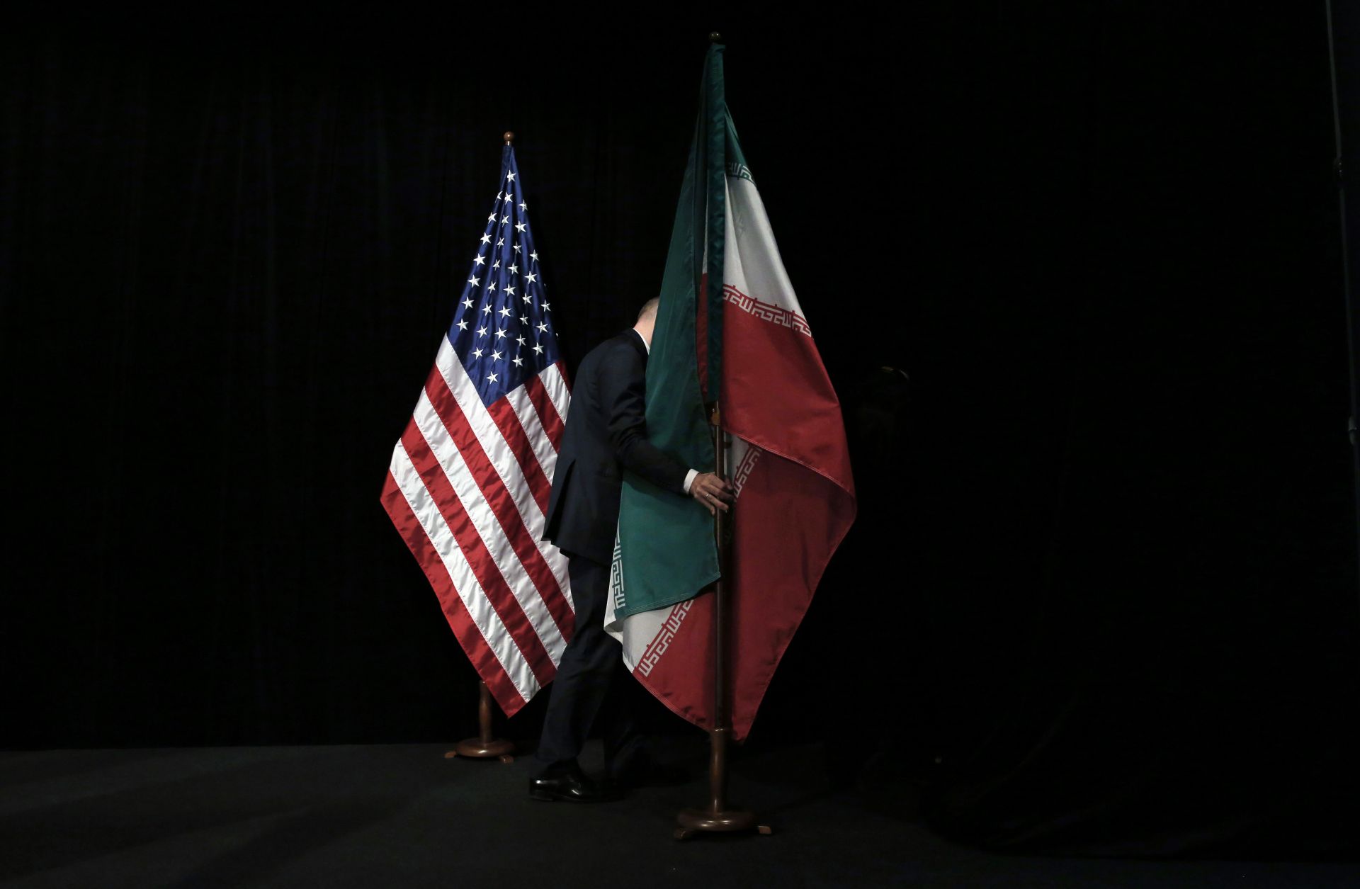 The U.S. and Iranian flags are seen on a stage during nuclear talks in Vienna, Austria. 
