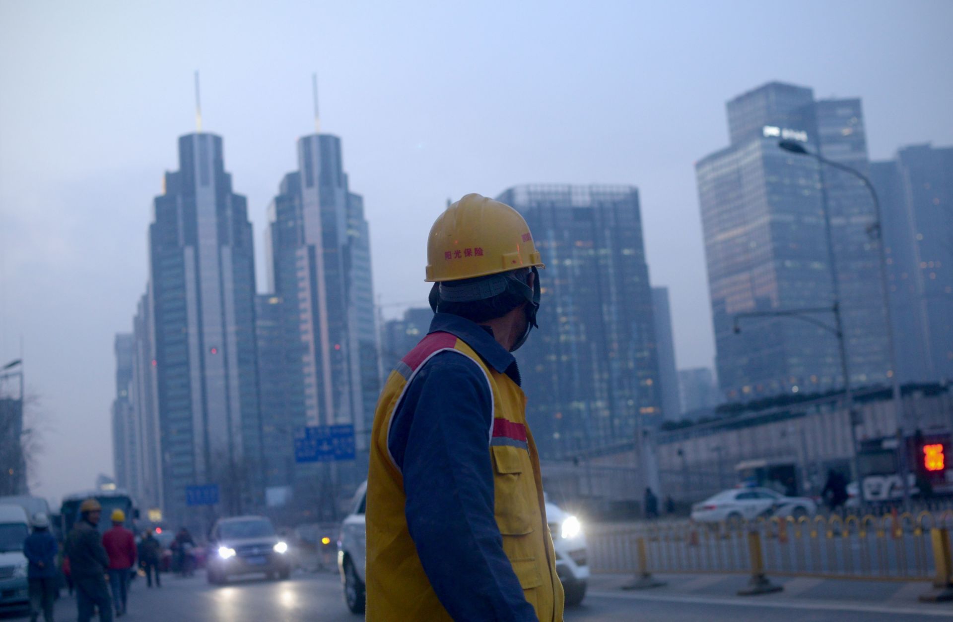 A Chinese worker looks on as he walks along a street in Beijing after finishing his shift.