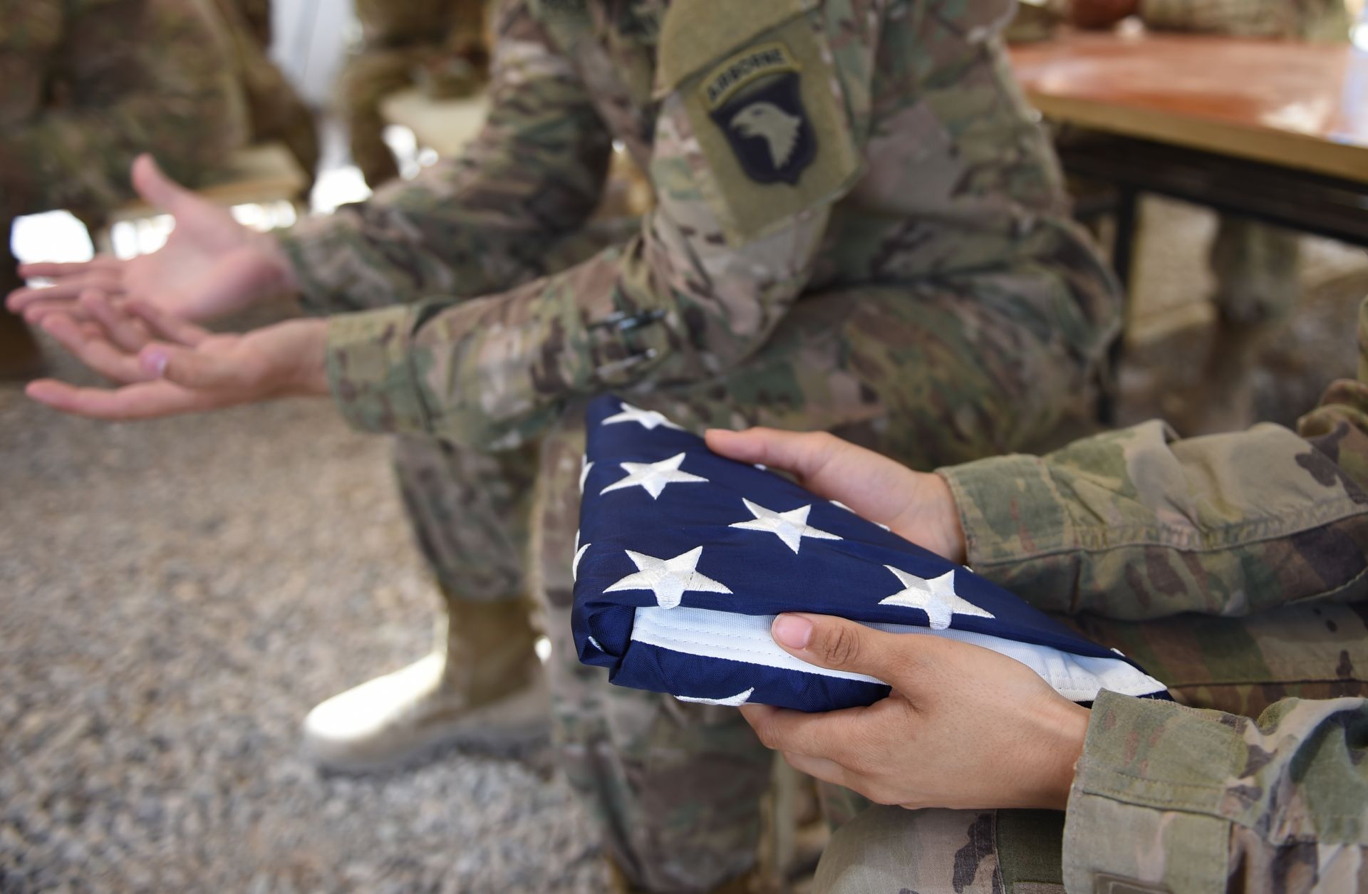 A U.S. soldier holds the national flag ahead of a handover ceremony at CampLeatherneck in Lashkar Gah in the Afghan province of Helmand on April 29.
