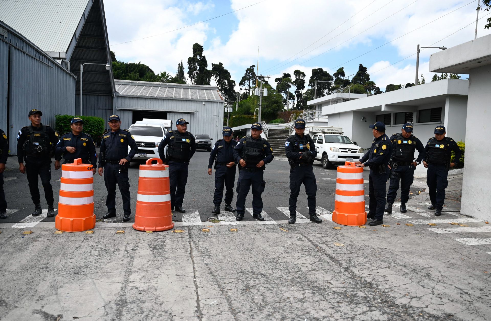 Police officers remain at the entrance of the Electoral Process Operations Center during government raids in Guatemala City on Sept. 12, 2023.