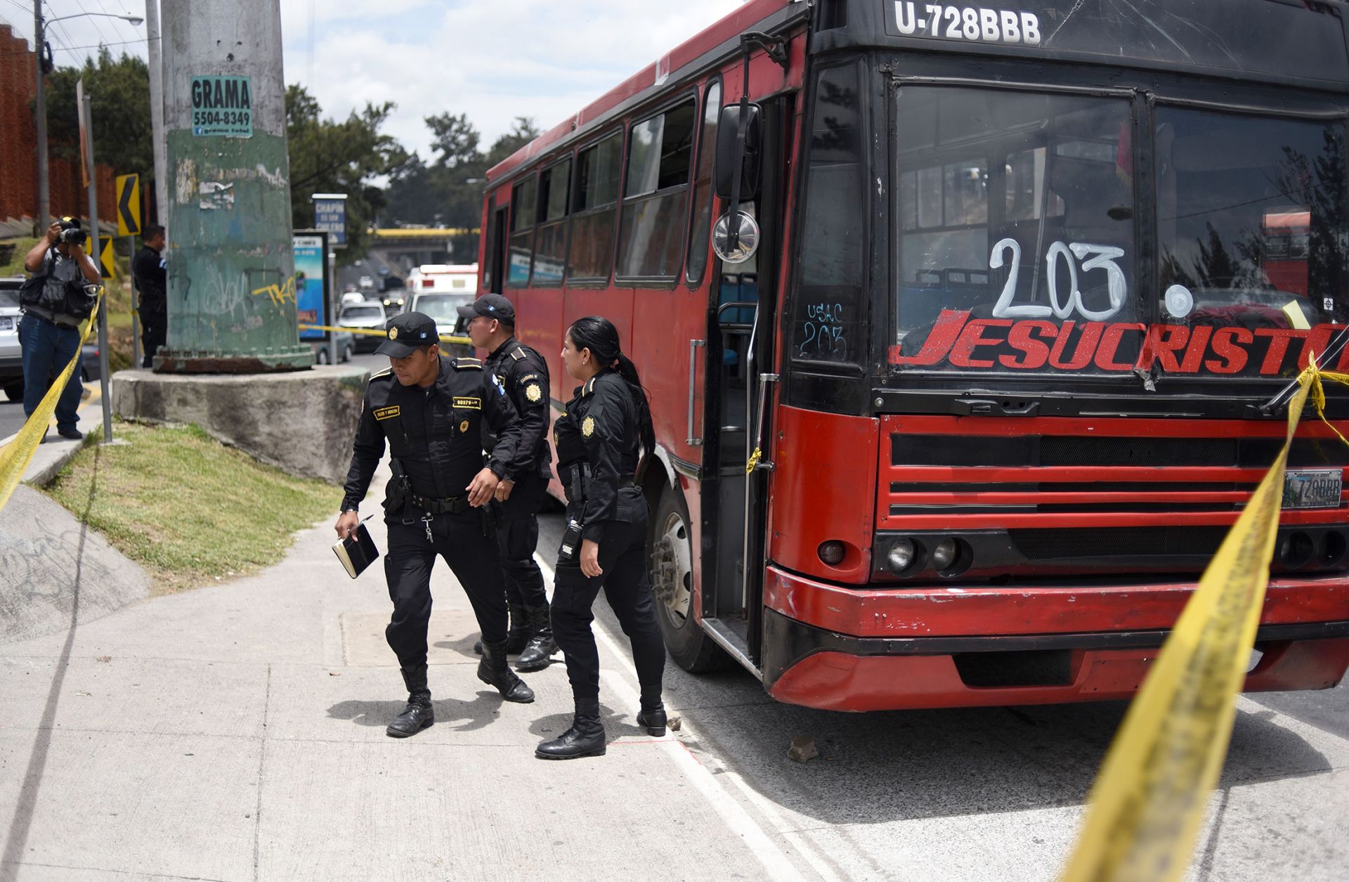 Police inspect one of four buses attacked by alleged gang members July 13, 2018, in Guatemala City.