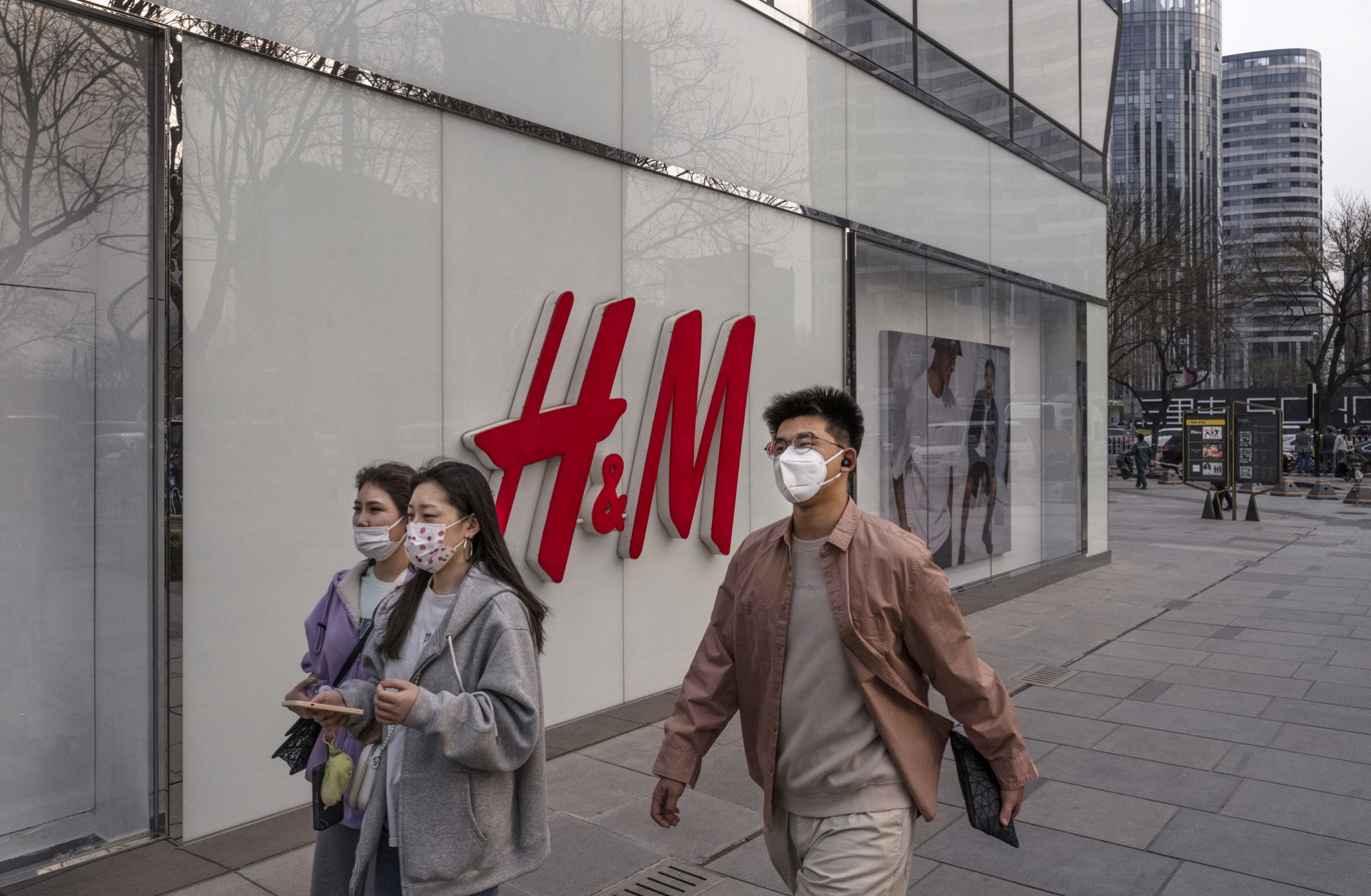 People walk past an H&M store in Beijing, China, on March 25, 2021. 