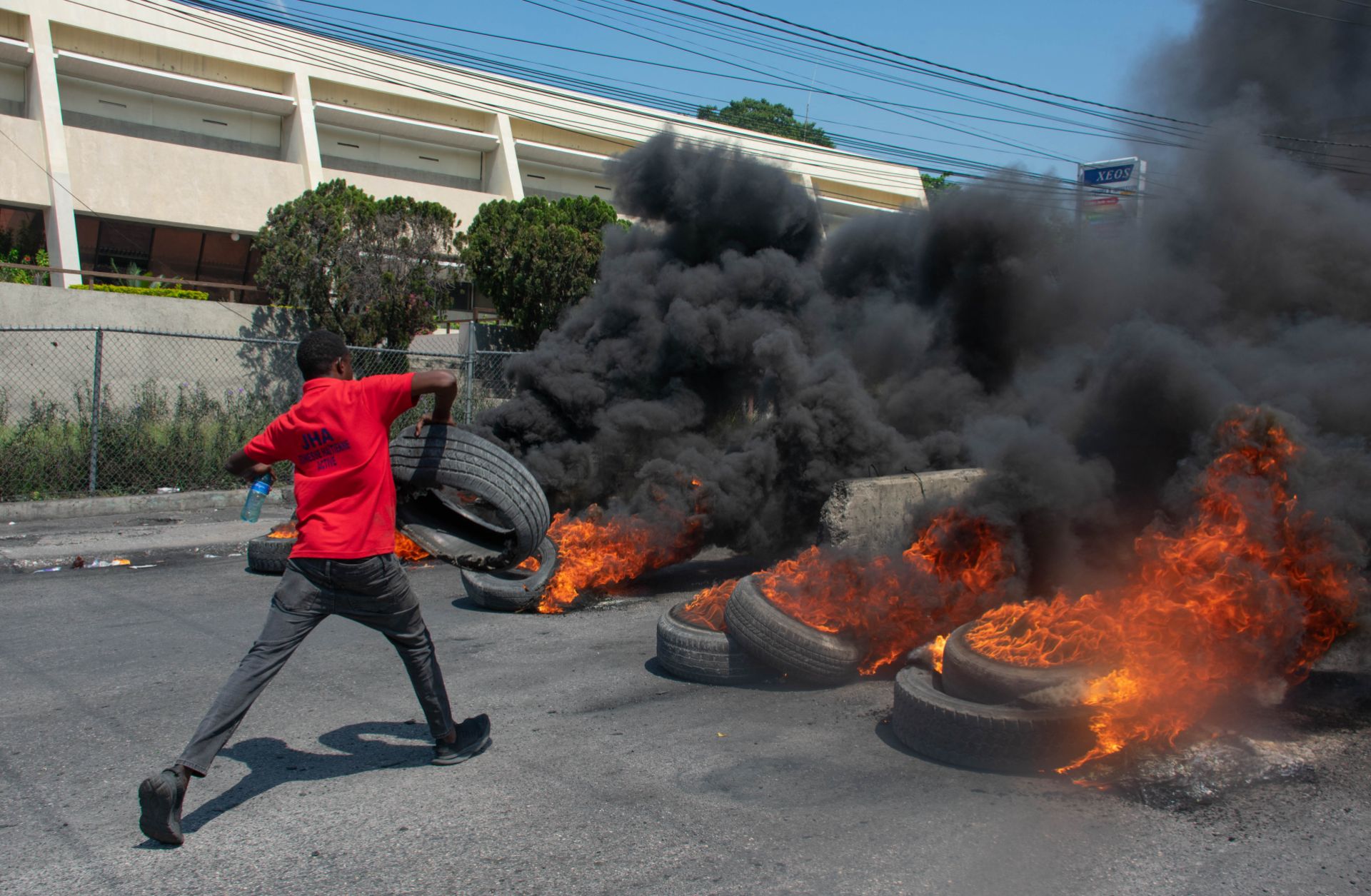 A protester burns tires during a demonstration in Port-au-Prince, Haiti, on March 12, 2024, after Haitian Prime Minister Ariel Henry announced his plans to resign. 