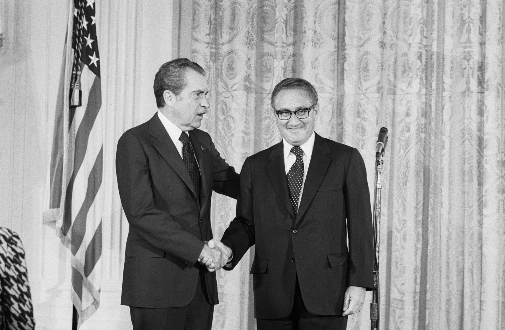 Then-U.S. President Richard Nixon (left) congratulates Henry Kissinger after he was sworn in as Secretary of State in the East Room of the White House on Sept. 22, 1973.