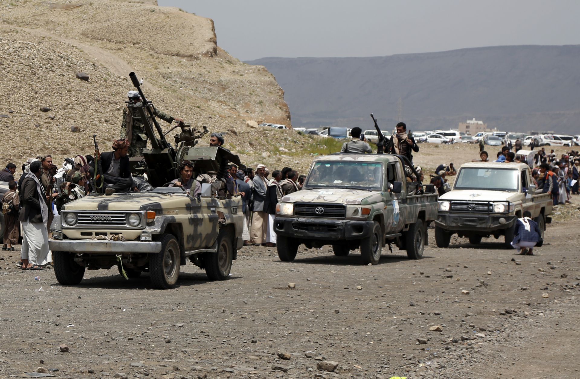 Houthi-allied tribesmen ride trucks mounted with machine guns on the outskirts of Sanaa, Yemen, on July 8, 2020. 