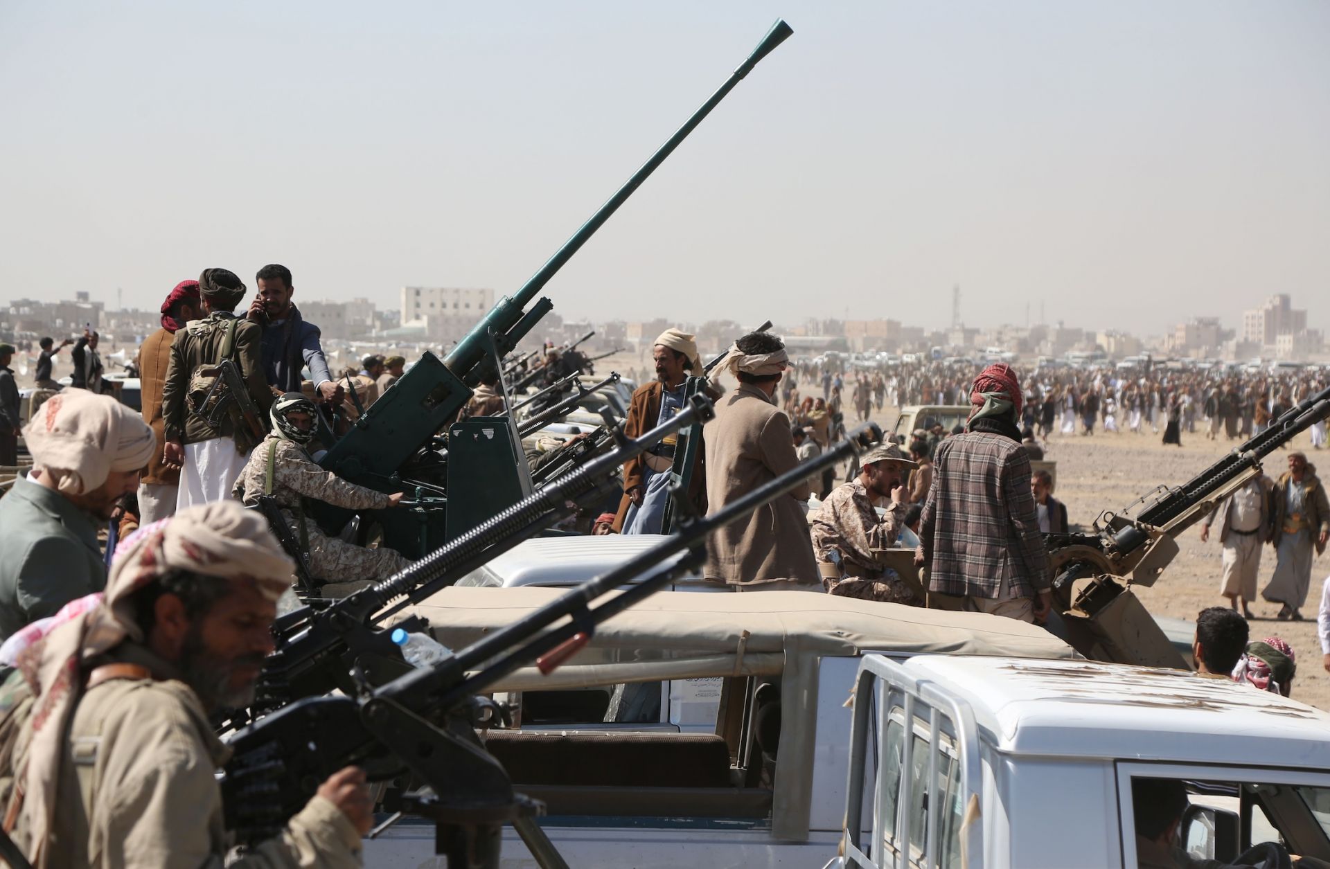Yemen's Houthi fighters man machine guns mounted on trucks as they participate in a weaponized protest staged against the United States and Israel on Nov. 6, 2025 in Sanaa, Yemen. 