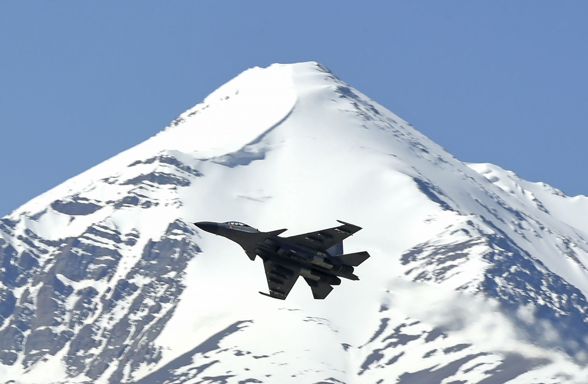 An Indian fighter jet flies over a mountain range near the disputed territory of Ladakh on June 23, 2020. An Indian fighter jet flies over a mountain range near the disputed territory of Ladakh on June 23, 2020.
