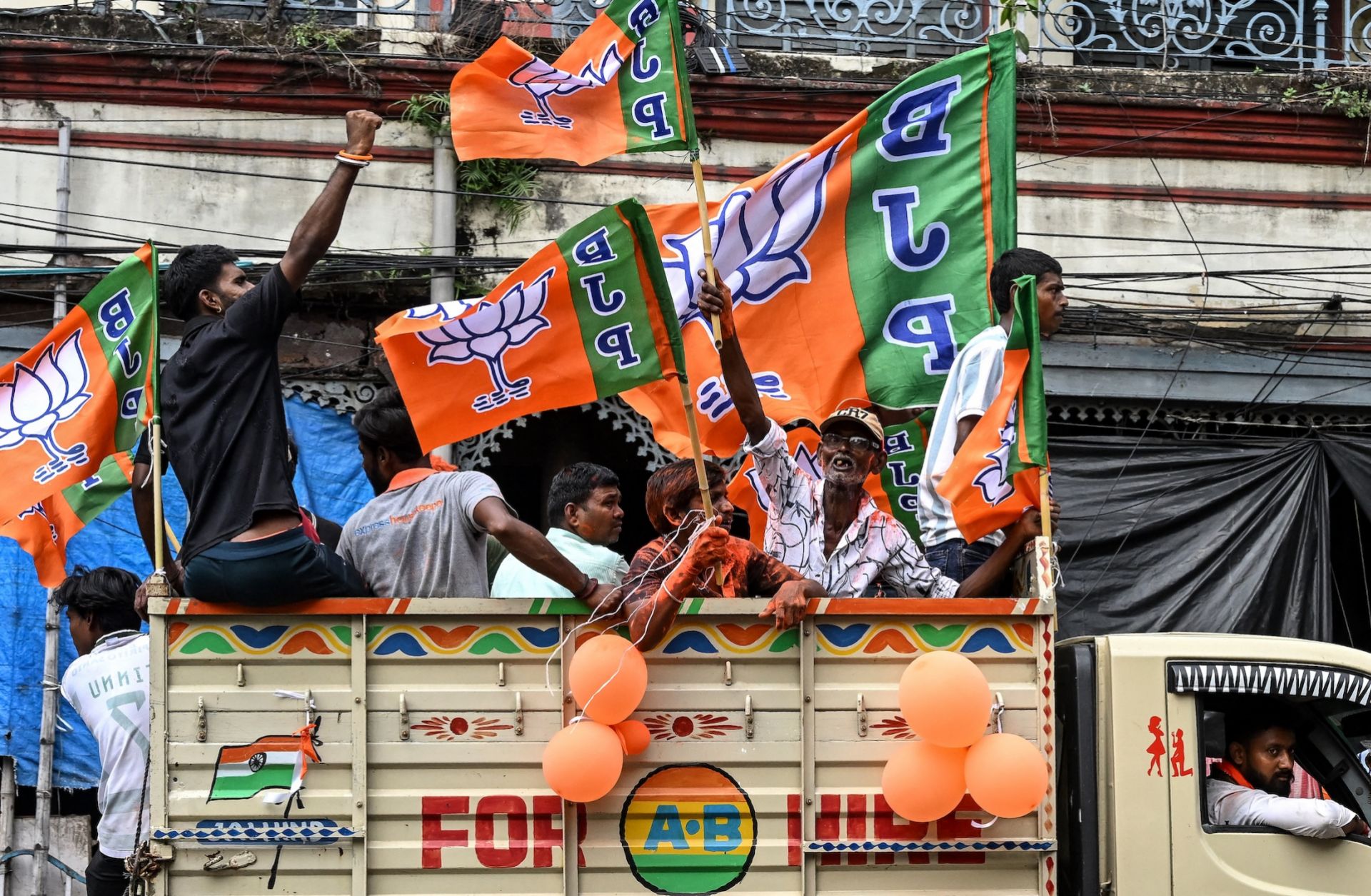 Supporters of the Bharatiya Janata Party (BJP) celebrate with the party flags in Kolkata, India, following state elections in West Bengal.