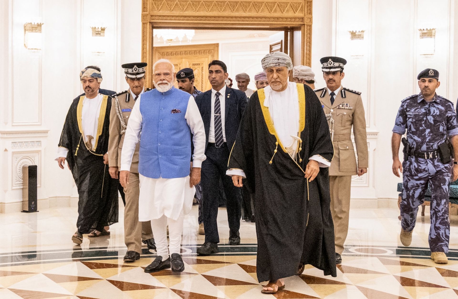 Indian Prime Minister Narendra Modi walks alongside Oman's Deputy Prime Minister for Defence Affairs Sayyid Shihab bin Tariq al-Said upon his arrival in Muscat on Dec. 17, 2025.