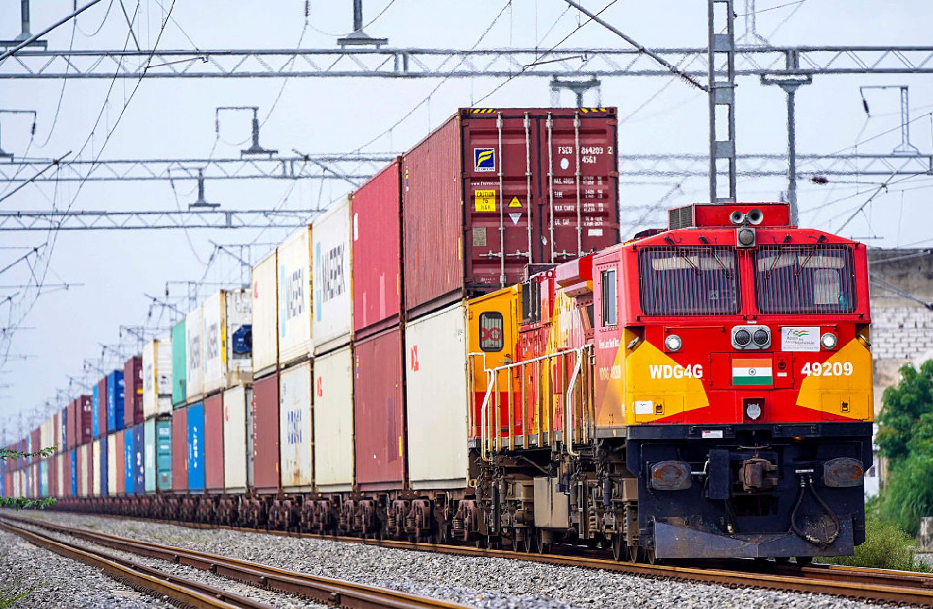 A freight train carrying cargo containers rides along a railway track in Ajmer, India, on Aug. 26, 2025. 