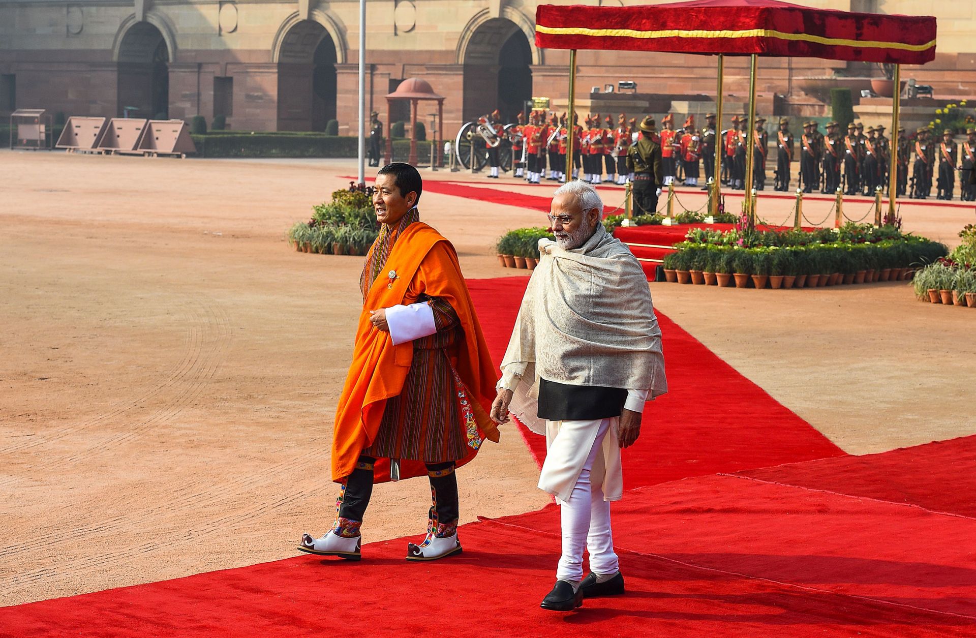 Indian Prime Minister Narendra Modi (R) walks with Bhutanese Prime Minister Lotay Tshering during a ceremonial reception at the Presidential Palace in New Delhi on Dec. 28, 2018.