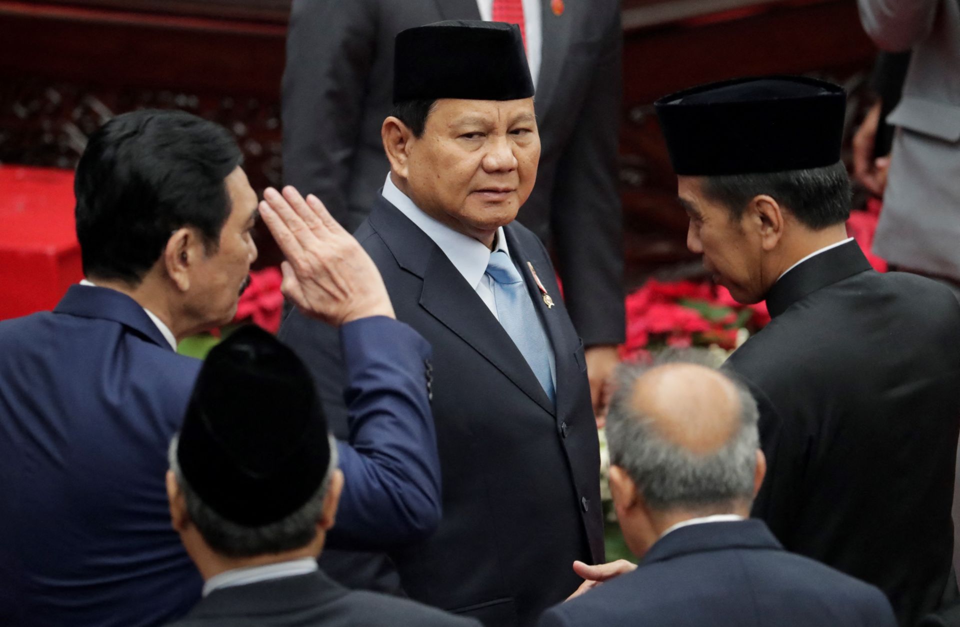 Indonesian Defense Minister and President-elect Prabowo Subianto (center) is seen next to outgoing President Joko Widodo (right) in the parliament building in Jakarta on Aug. 16, 2024. 