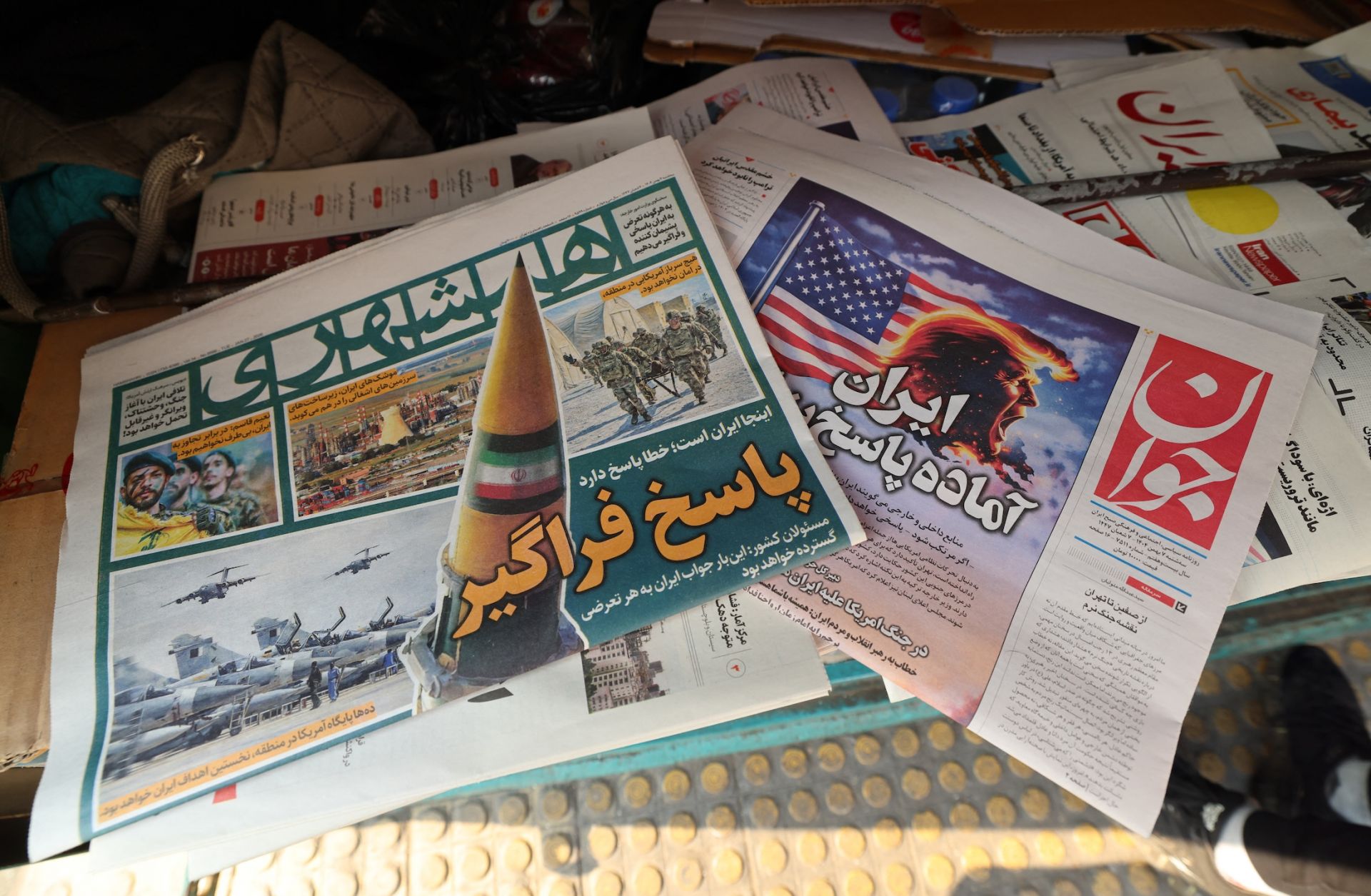 Iranian newspapers one of them (R) with a headline in Persian reading "Iran is ready for a big response," Jan. 27 in Tehran in Iran.