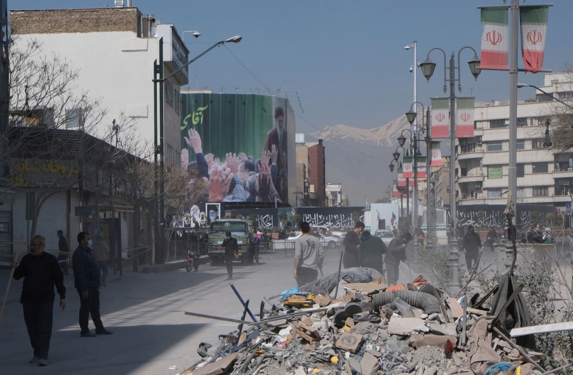Volunteers clean up the rubble outside a government building in Tehran, Iran, that was destroyed by U.S. and Israeli strikes on March 4, 2026.