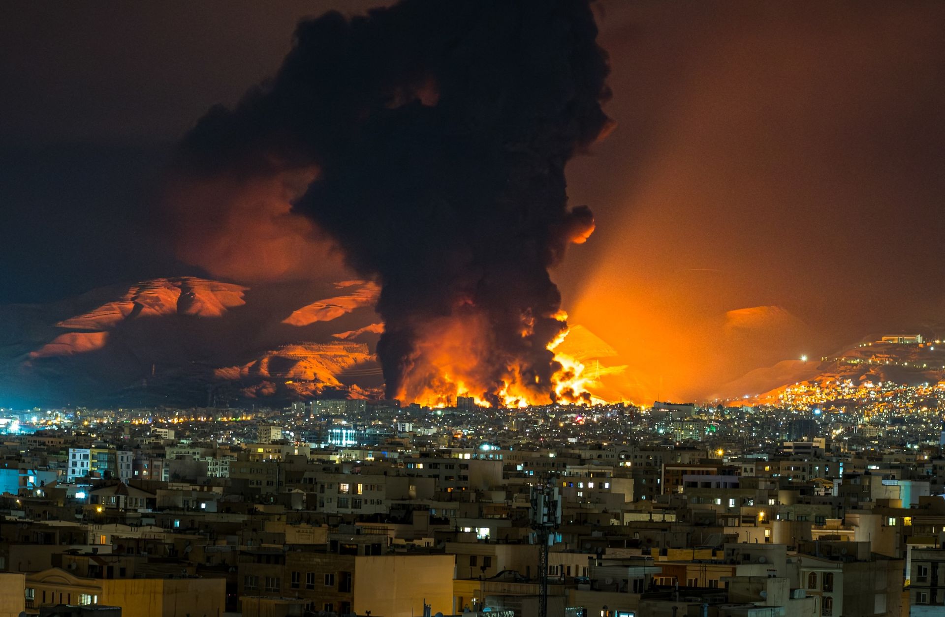 Smoke and flames rise at the site of airstrikes on an oil depot in Tehran, Iran, on March 7, 2026.