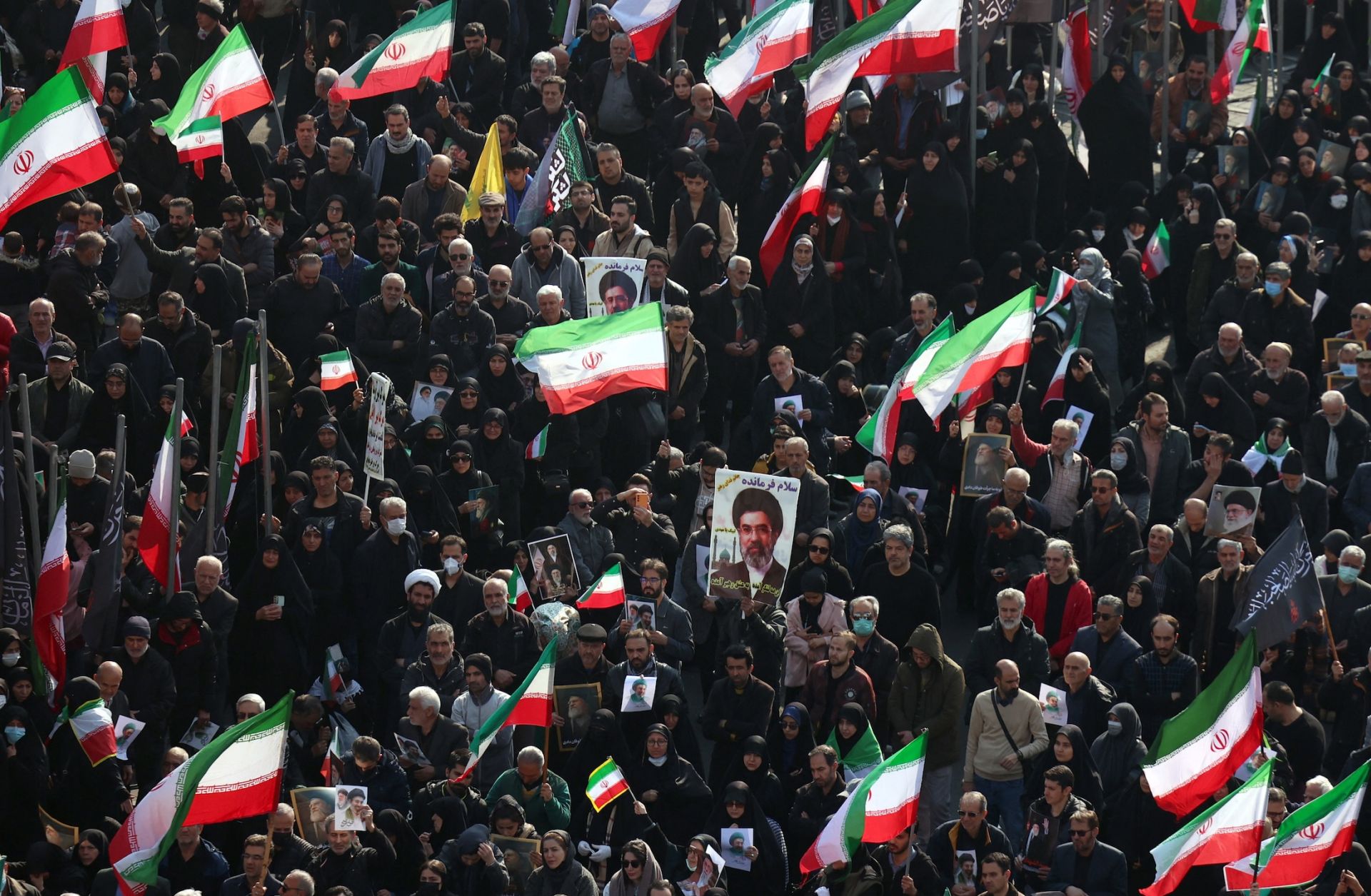Demonstrators wave Iranian national flags and hold pictures of the country's new supreme leader, Mojtaba Khamenei, at Enghelab Square in central Tehran on March 9, 2026.