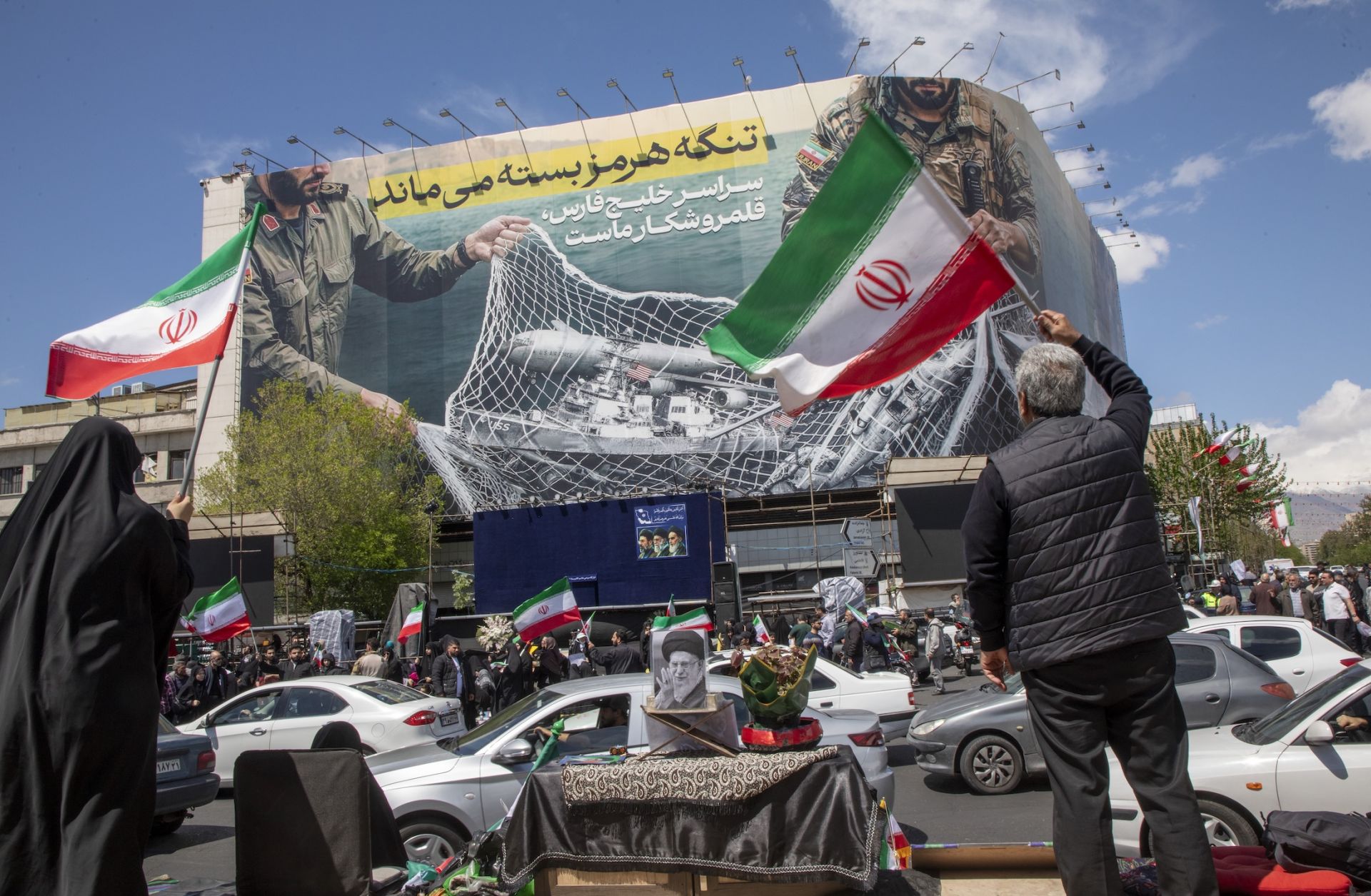 Iranians hold national flags as they gather in Tehran's Revolution Square after the United States and Iran agreed to a two-week ceasefire, on April 8, 2026 in Tehran, Iran. Iranians hold national flags as they gather in Tehran's Revolution Square after the United States and Iran agreed to a two-week ceasefire, on April 8, 2026 in Tehran, Iran.