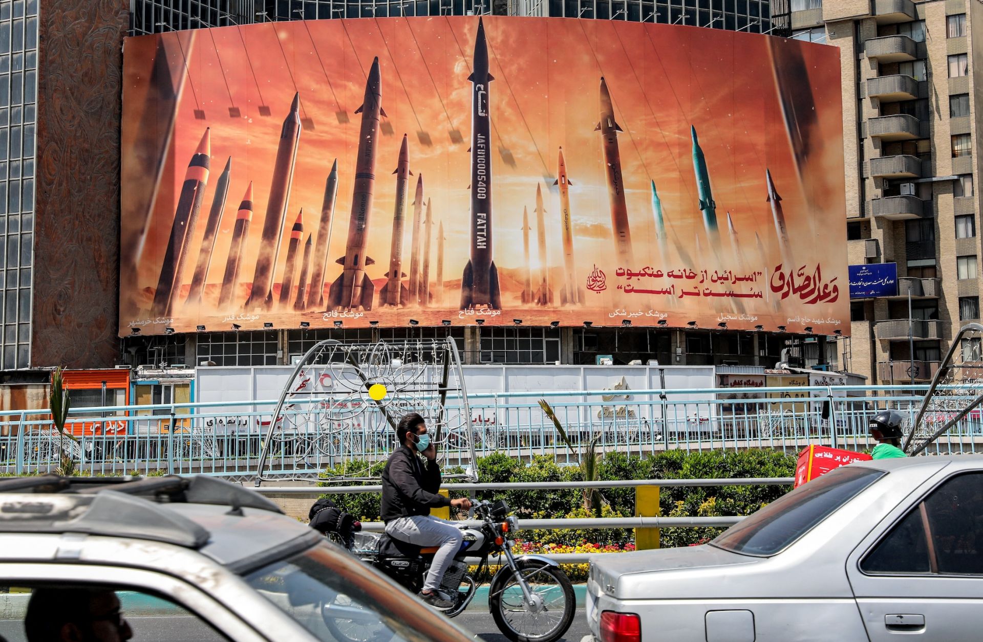 A banner depicts IRGC missile models aimed at Israel on April 16 in the Iranian capital of Tehran.