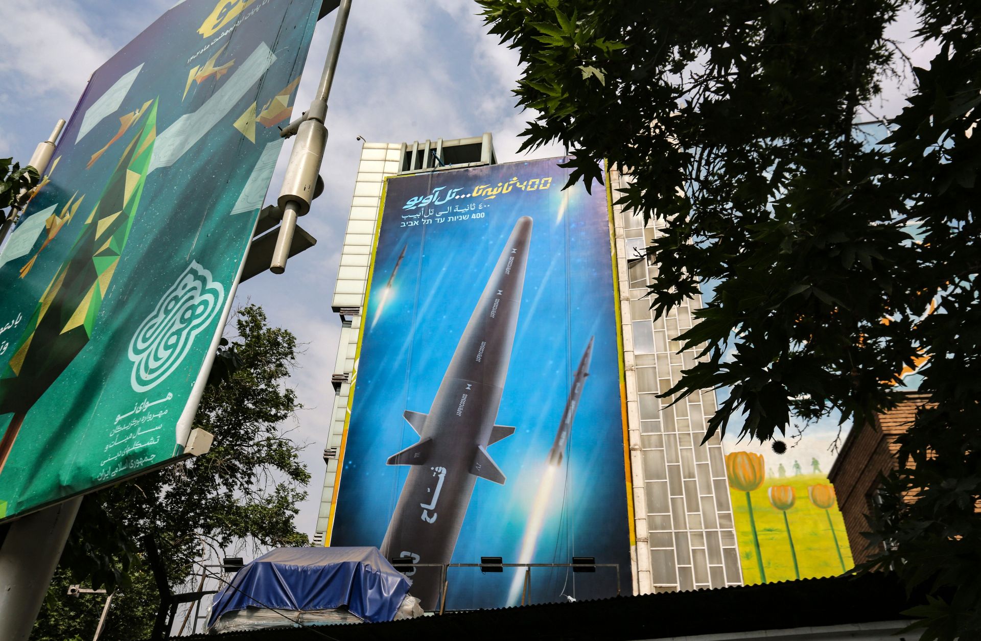 A giant billboard bearing a picture of Iran's "Fattah" hypersonic missile covers the side of a building in Tehran on July 7, 2023.